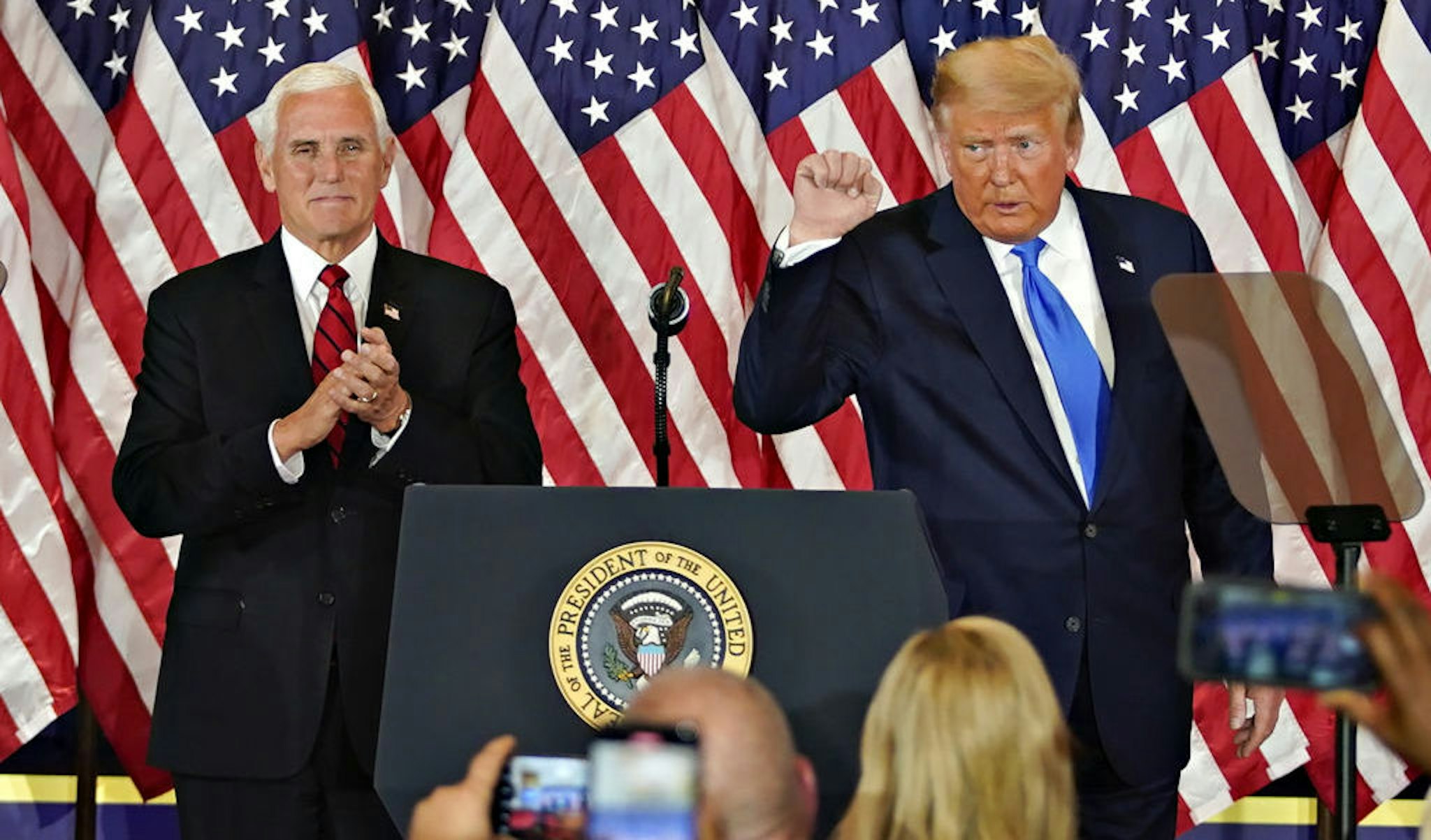 U.S. President Donald Trump gestures after speaking during an election night party with U.S. Vice President Mike Pence, left, in the East Room of the White House in Washington, D.C., U.S., on Wednesday, Nov. 4, 2020. Trump declared he had won re-election against Joe Biden and said he would ask the Supreme Court to intervene, even as several battleground states continue to count votes. Photographer: Al Drago/Bloomberg