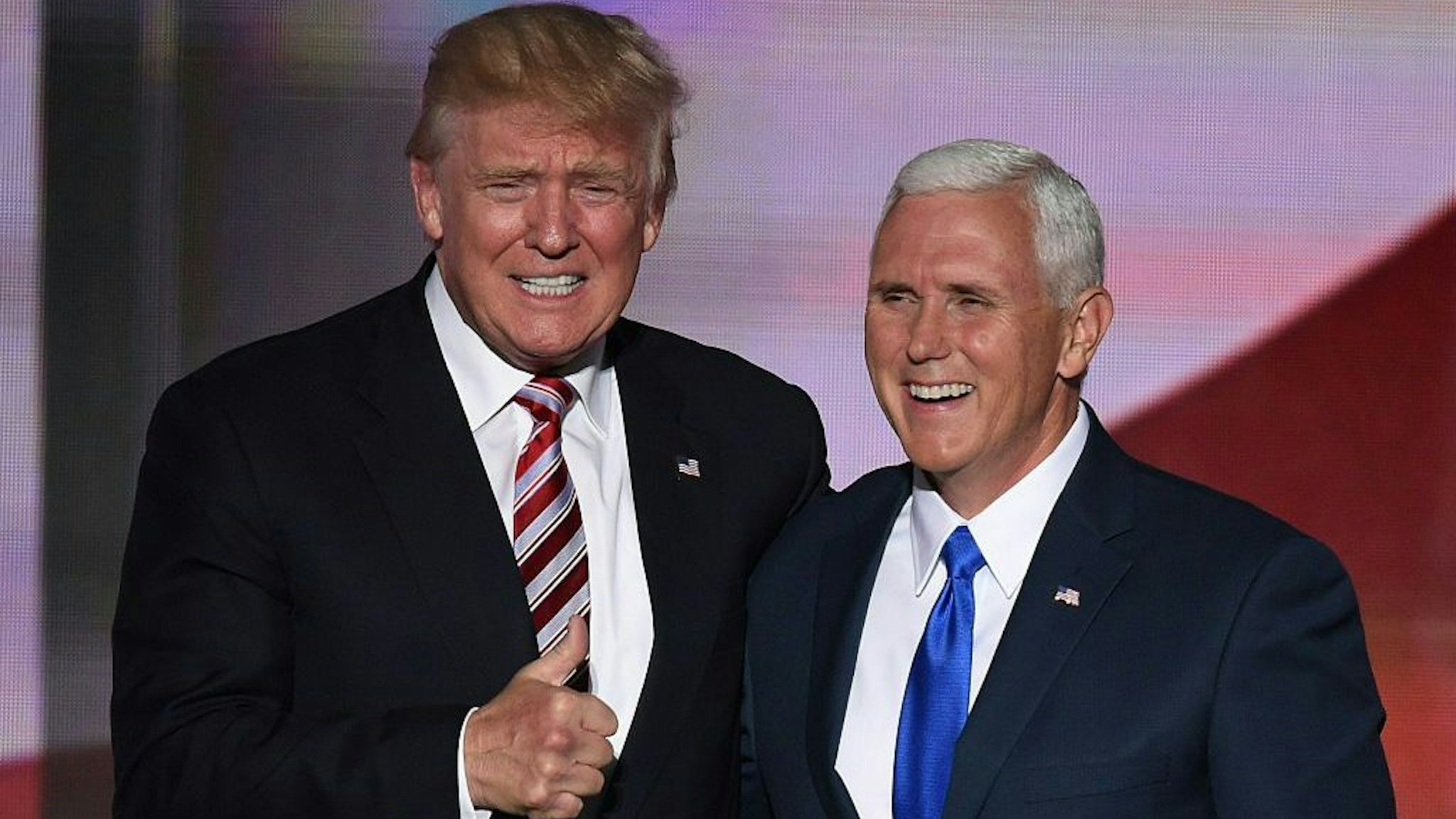 Republican presidential candidate Donald Trump (L)gives the thumbs-up as he stands with vice presidential candidate Mike Pence at the end of the third day of the Republican National Convention at the Quicken Loans Arena in Cleveland, Ohio on July 20, 2016. (Photo credit should read TIMOTHY A. CLARY/AFP via Getty Images)