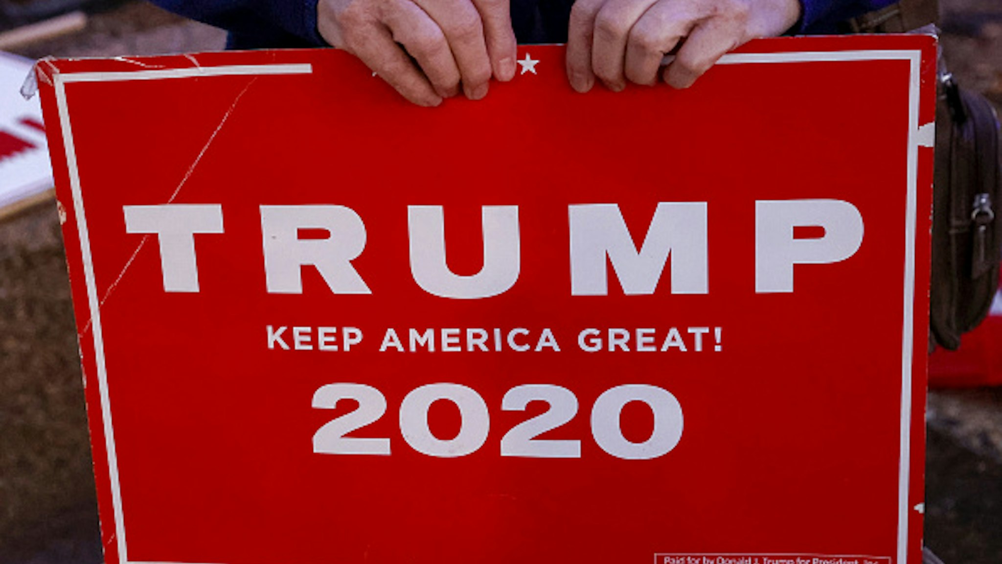 An Israeli supporter of US President Donald Trump carries a sign during a rally in the northern Israeli city of Karmiel near Haifa on November 3, 2020, to express their support for him during the US presidential election.