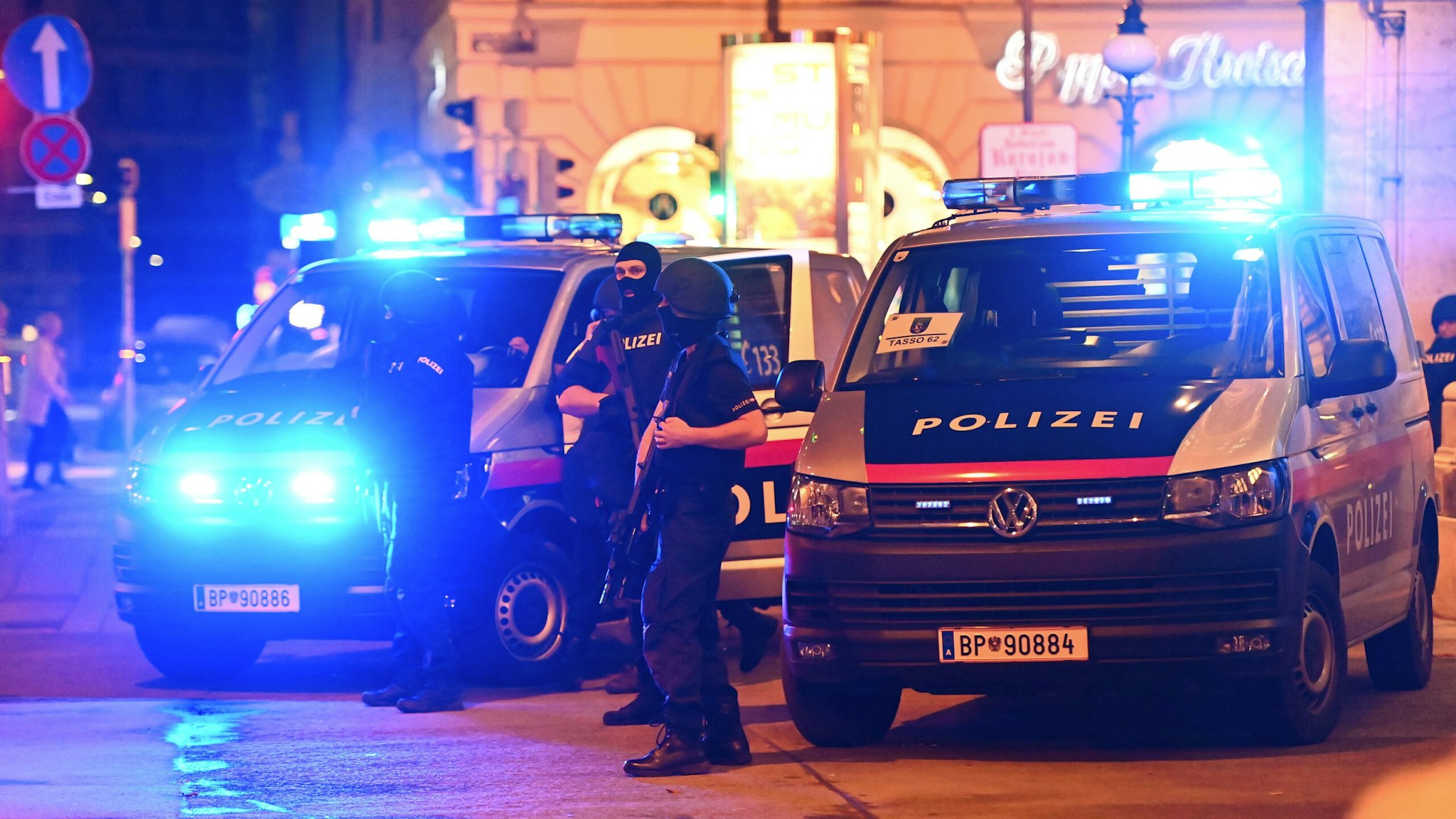 Police cars and policemen stand in the central Vienna on November 2, 2020, following a shooting near a synagogue. - Multiple gunshots were fired in central Vienna on the evening of November 2, 2020, according to police, with the location of the incident close to a major synagogue. Police urged residents to keep away from all public places or public transport. One attacker was "dead" and another "on the run", with one police officer being seriously injured, Austria's interior ministry said according to news agency APA.