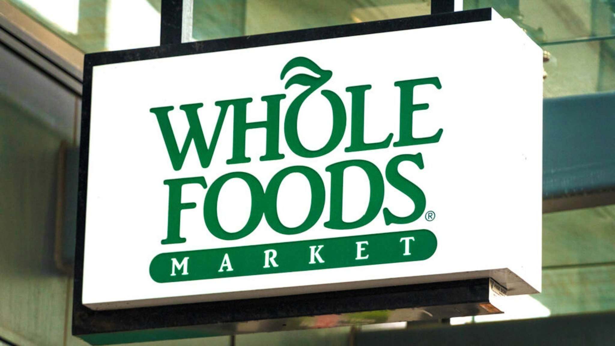 TORONTO, ONTARIO, CANADA - 2017/10/22: Whole Foods sign hanging on a store entrance in Yonge Street. The company was recently acquired by Amazon.