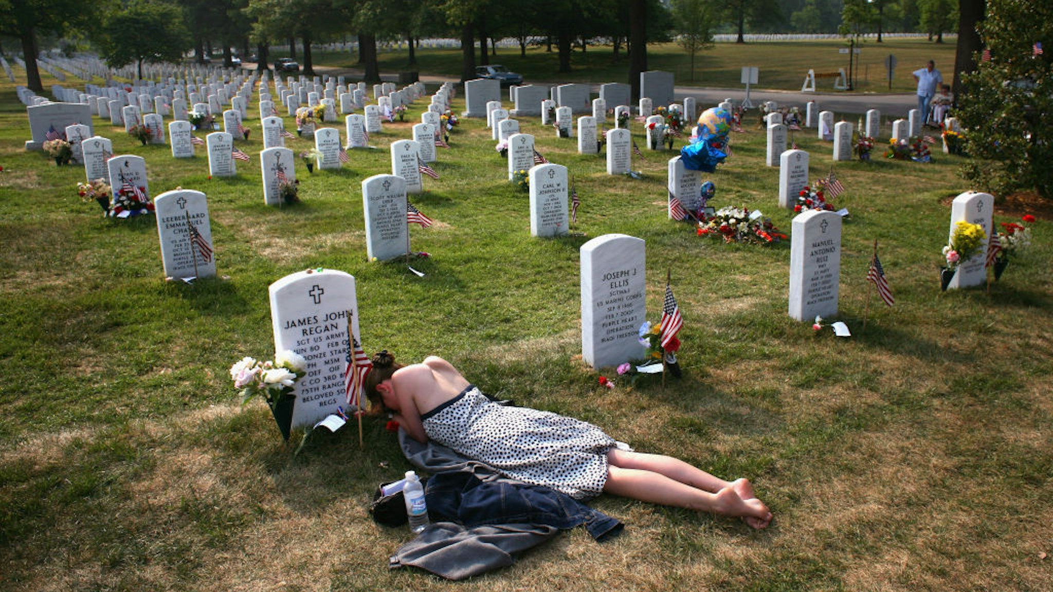 ARLINGTON, VA - MAY 27: Mary McHugh mourns her slain fiance Sgt. James Regan at "Section 60" of the Arlington National Cemetery May 27, 2007. Regan, a US Army Ranger, was killed by an IED explosion in Iraq in February of this year, and this was the first time McHugh had visited the grave since the funeral. Section 60, the newest portion of the vast national cemetery on the outskirts of Washington D.C, contains hundreds of U.S. soldiers killed in Iraq and Afghanistan. Family members of slain American soldiers have flown in from across the country for Memorial Day. (Photo by John Moore/Getty Images)