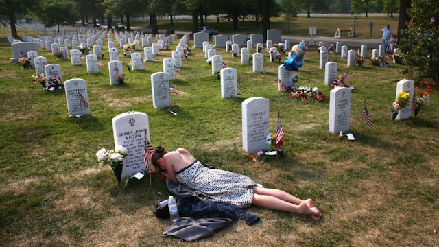 ARLINGTON, VA - MAY 27: Mary McHugh mourns her slain fiance Sgt. James Regan at "Section 60" of the Arlington National Cemetery May 27, 2007. Regan, a US Army Ranger, was killed by an IED explosion in Iraq in February of this year, and this was the first time McHugh had visited the grave since the funeral. Section 60, the newest portion of the vast national cemetery on the outskirts of Washington D.C, contains hundreds of U.S. soldiers killed in Iraq and Afghanistan. Family members of slain American soldiers have flown in from across the country for Memorial Day. (Photo by John Moore/Getty Images)