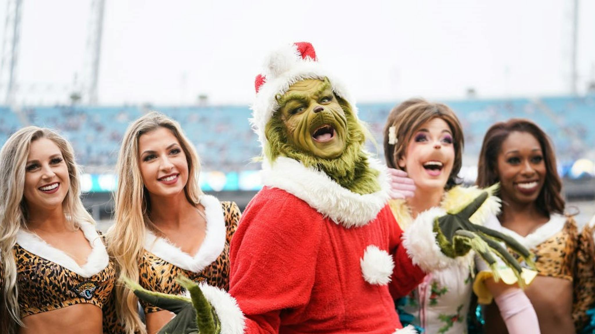 Los Angeles Chargers v Jacksonville Jaguars JACKSONVILLE, FLORIDA - DECEMBER 08: The Grinch poses with cheerleaders from the Jacksonville Jaguars before the start of a game against the Los Angeles Chargers at TIAA Bank Field on December 08, 2019 in Jacksonville, Florida. (Photo by