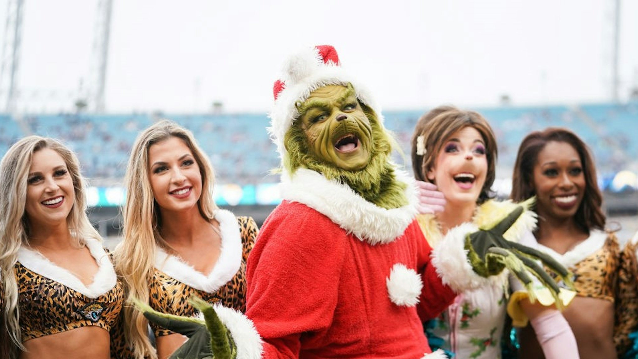 JACKSONVILLE, FLORIDA - DECEMBER 08: The Grinch poses with cheerleaders from the Jacksonville Jaguars before the start of a game against the Los Angeles Chargers at TIAA Bank Field on December 08, 2019 in Jacksonville, Florida. (Photo by