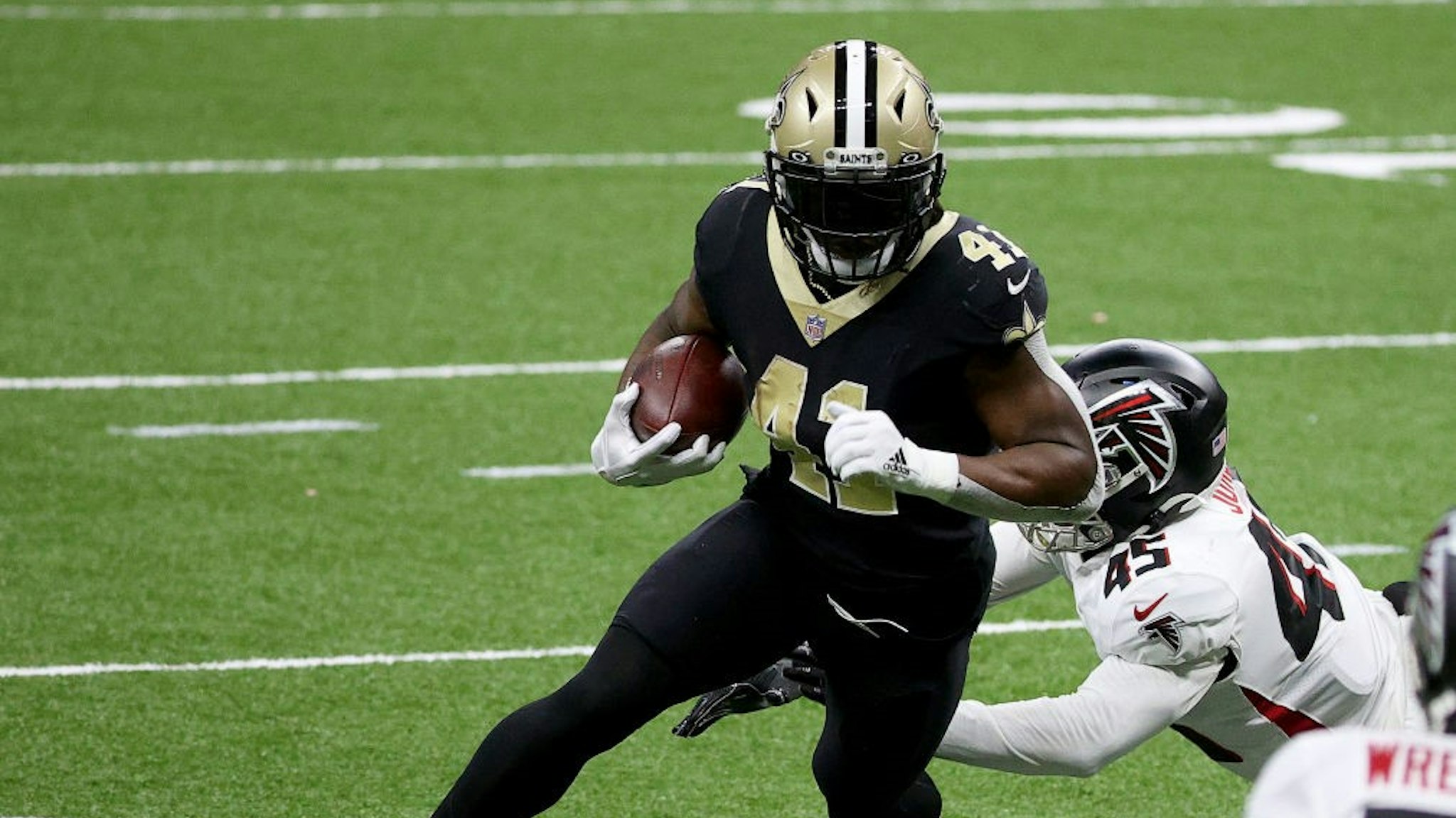 NEW ORLEANS, LOUISIANA - NOVEMBER 22: Alvin Kamara #41 of the New Orleans Saints carries the ball in for a touchdown as Deion Jones #45 of the Atlanta Falcons fails to make the tackle in the second quarter at Mercedes-Benz Superdome on November 22, 2020 in New Orleans, Louisiana. (Photo by