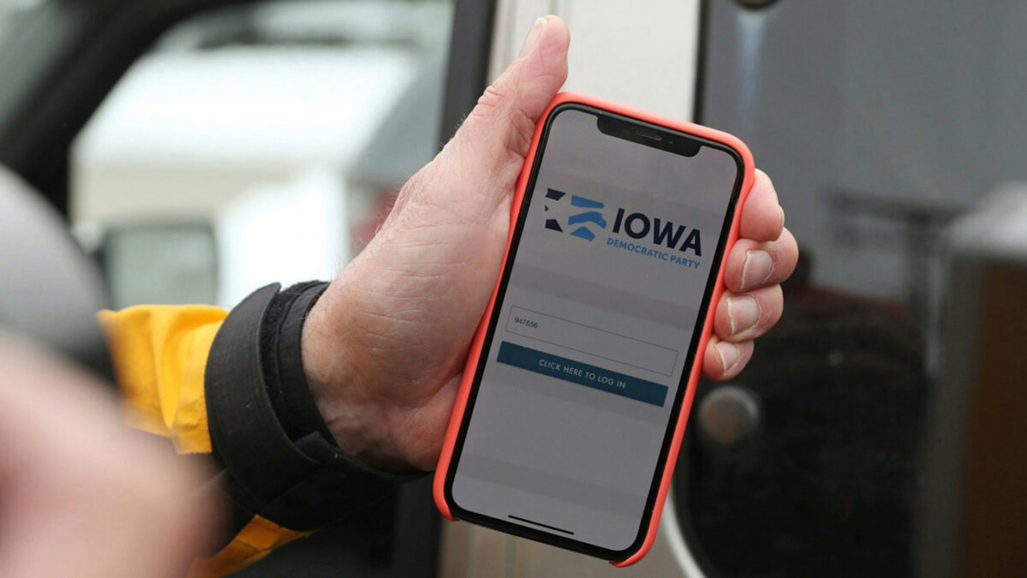 Precinct Chair Carl Voss shows the phone app he used for the Iowa Caucus to news media at the Iowa Democratic Party headquarters on February 4, 2020, in Des Moines, Iowa.