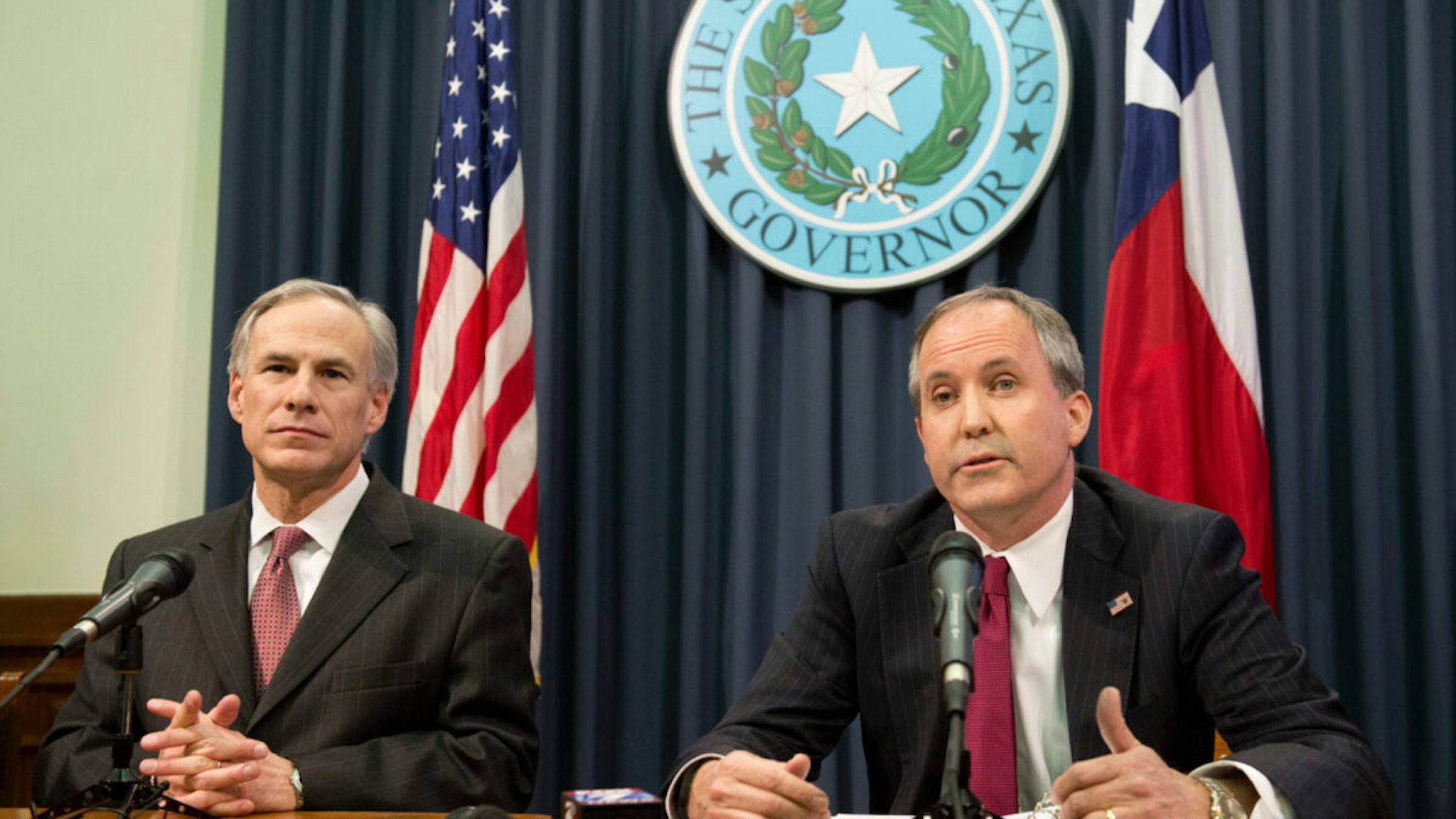 Texas Gov. Greg Abbott, l, and Attorney General Ken Paxton hold a press conference to address a Texas federal court's decision on the immigration lawsuit filed by 26 states challenging President Obama.