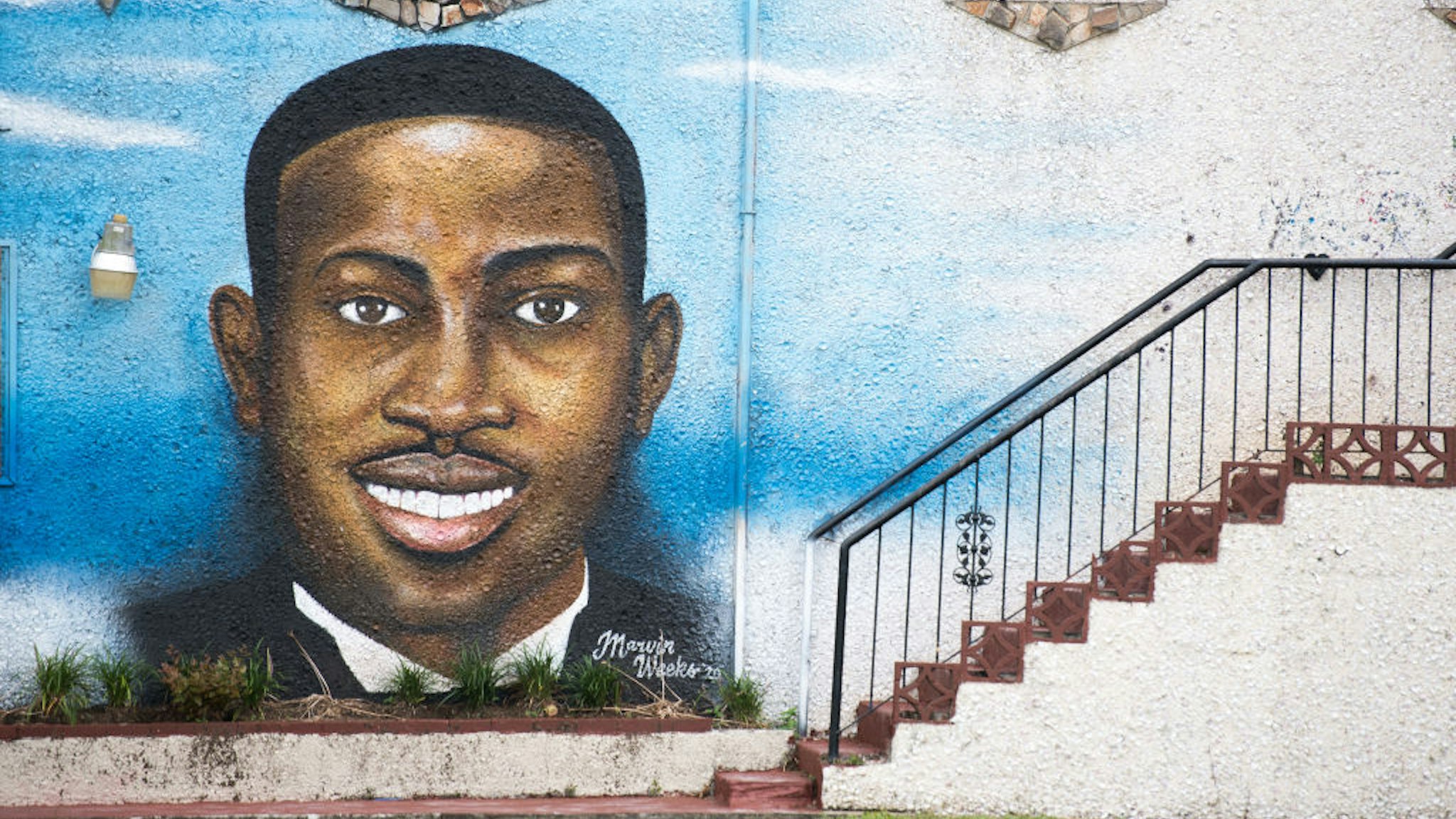 BRUNSWICK, GA - JULY 17: A mural depicting Ahmaud Arbery on July 17, 2020 in Brunswick, Georgia. Gregory McMichael, Travis McMichael, and William 'Roddie' Bryan appeared before a judge for the murder of Ahmaud Arbery. (Photo by Sean Rayford/Getty Images)