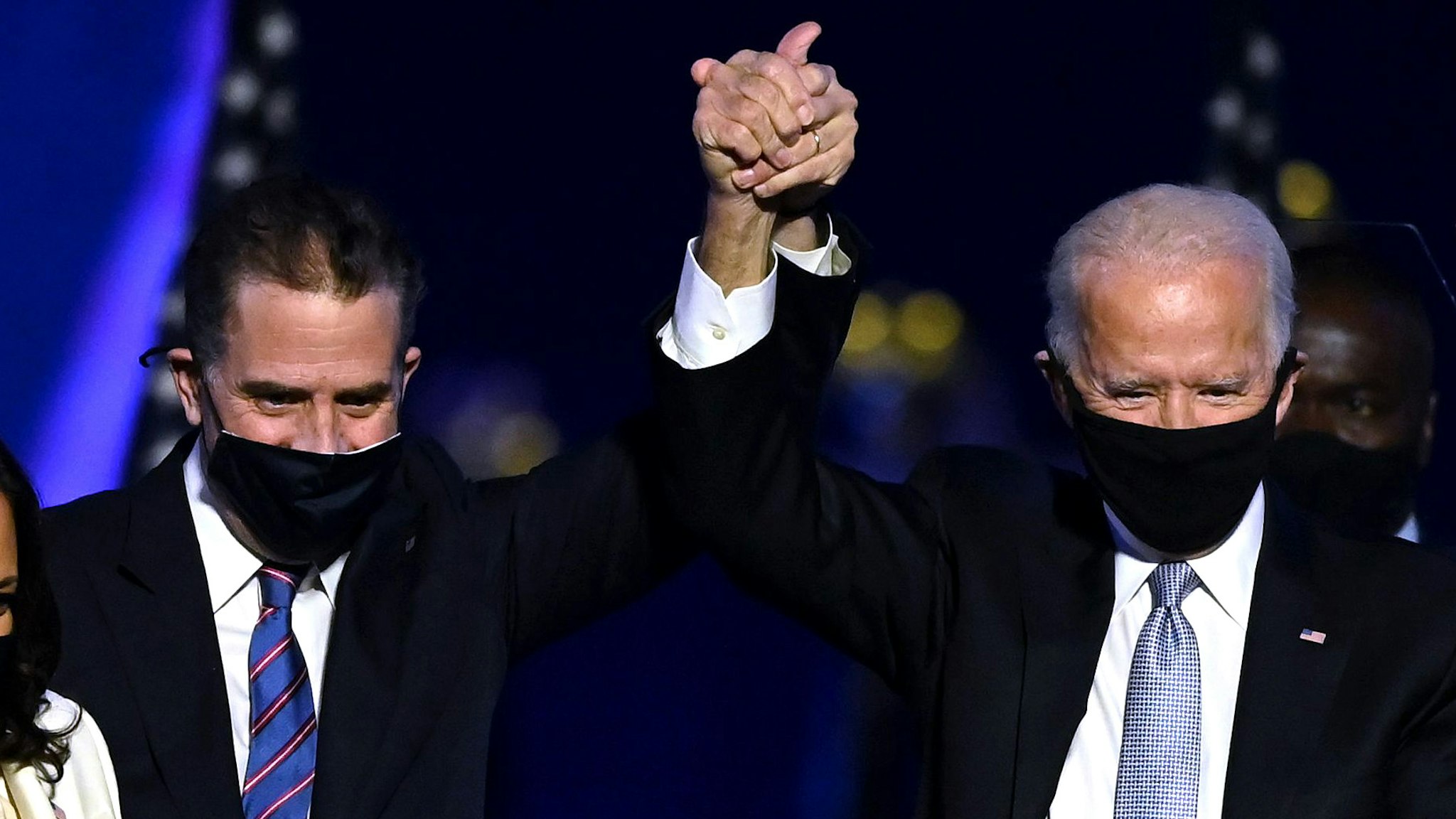 (From L) Husband of Vice President-elect Kamala Harris, Douglas Emhoff, Vice President-elect Kamala Harris, Hunter Biden, US President-elect Joe Biden and wife Jill Biden salute the crowd after delivering remarks in Wilmington, Delaware, on November 7, 2020, after being declared the winners of the presidential election.