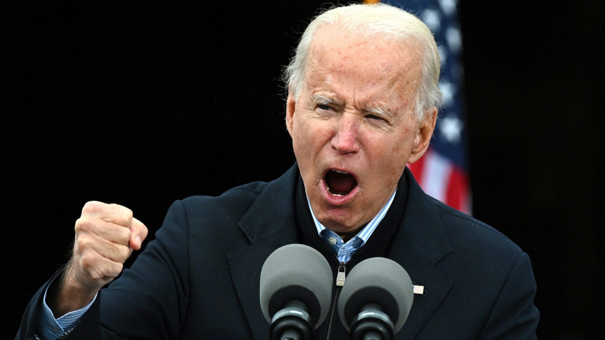 TOPSHOT - US President-elect Joe Biden gestures as he speaks during a campaign rally to support Democratic Senate candidates in Atlanta, Georgia on December 15, 2020. - US President-elect Joe Biden travelled to Georgia to campaign for Democratic Senate candidates Jon Ossoff and Reverend Raphael Warnock.