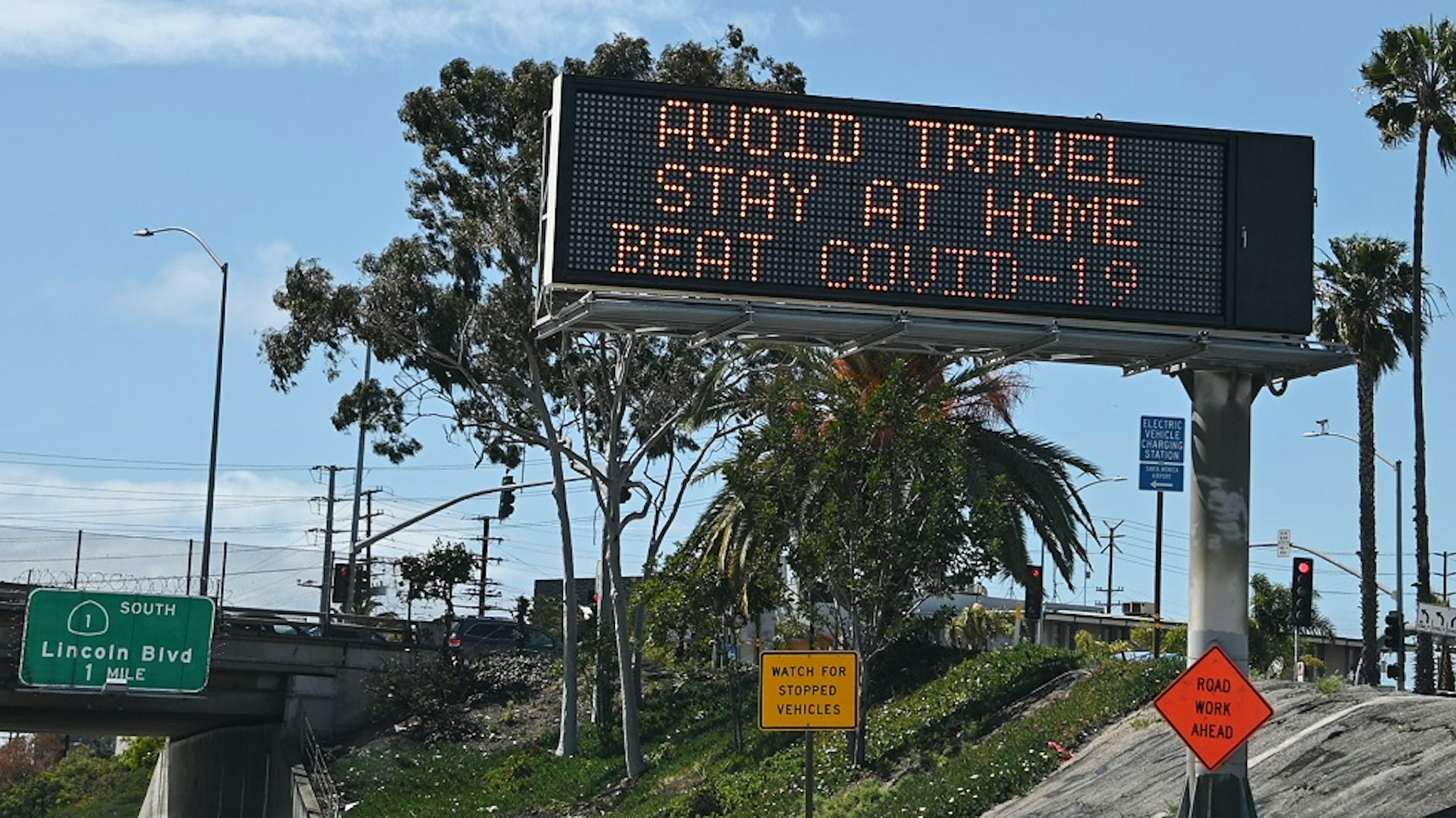 Highway digital signs display messages about stay home and avoiding travel during an outbreak of the COVID-19 coronavirus, Los Angeles, California, March 25, 2020.