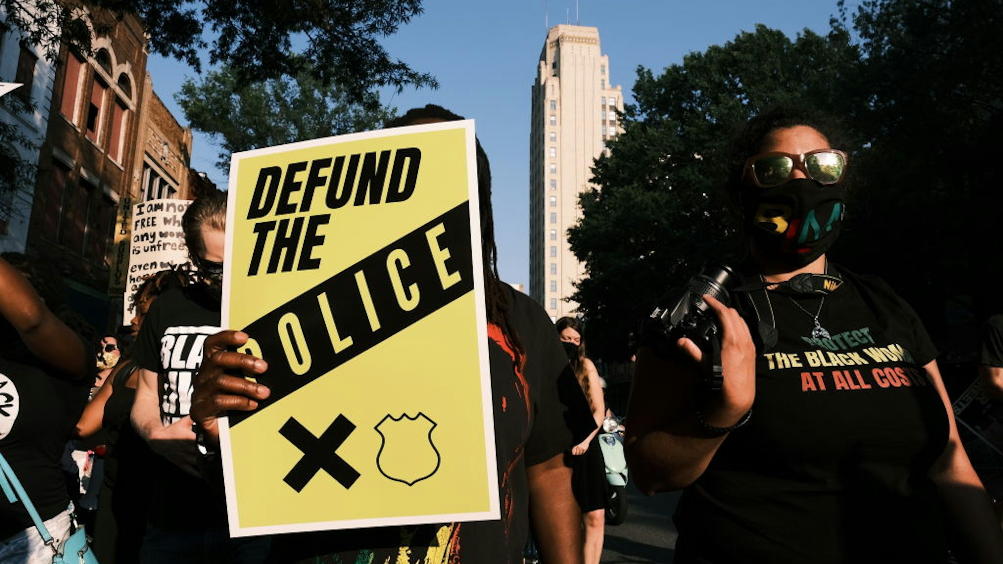 RICHMOND, VA - JULY 03: A protester carries a sign that reads "Defund The Police" during the Black Women Matter "Say Her Name" march on July 3, 2020 in Richmond, Virginia. Protests continue around the country after the death of African Americans while in police custody. (Photo by Eze Amos/Getty Images)