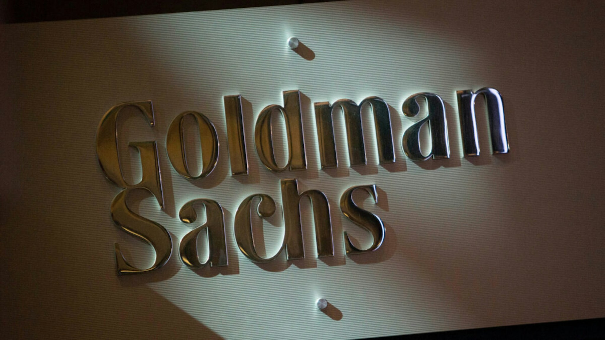 The Goldman Sachs & Co. logo is displayed at the company's booth on the floor of the New York Stock Exchange (NYSE) in New York, U.S., on Friday, July 19, 2013.