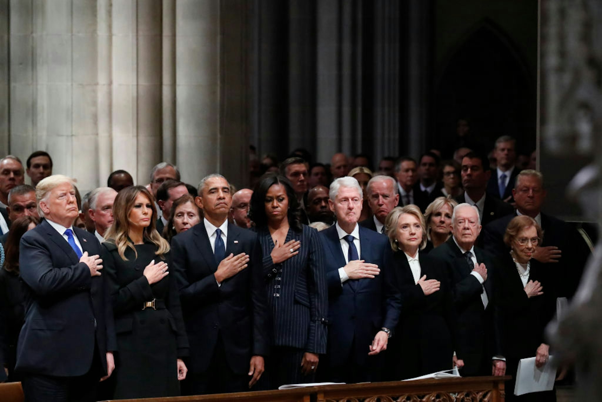 WASHINGTON, DC - DECEMBER 05: (AFP OUT) From left, President Donald Trump, first lady Melania Trump, former President Barack Obama, former first lady Michelle Obama, former President Bill Clinton, former Secretary of State Hillary Clinton, and former President Jimmy Carter and former first lady Rosalynn Carter attend the state funeral of former U.S. President George H. W. Bush at the Washington National Cathedral on December 5, 2018 in Washington, DC. President Bush will be buried at his final resting place at the George H.W. Bush Presidential Library at Texas A&amp;M University in College Station, Texas. A WWII combat veteran, Bush served as a member of Congress from Texas, ambassador to the United Nations, director of the CIA, vice president and 41st president of the United States. (Photo by Alex Brandon - Pool/Getty Images)