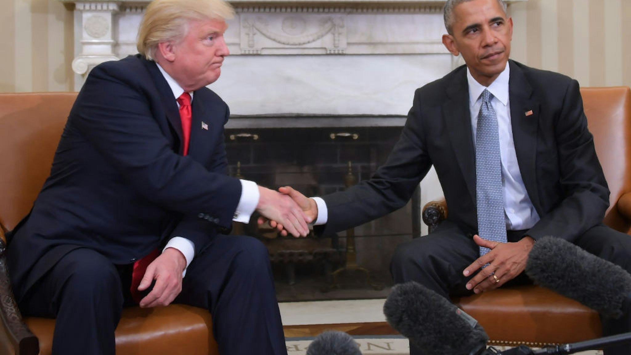 In this file photo taken on November 10, 2016, US President Barack Obama and President-elect Donald Trump shake hands during a transition planning meeting in the Oval Office at the White House in Washington, DC.