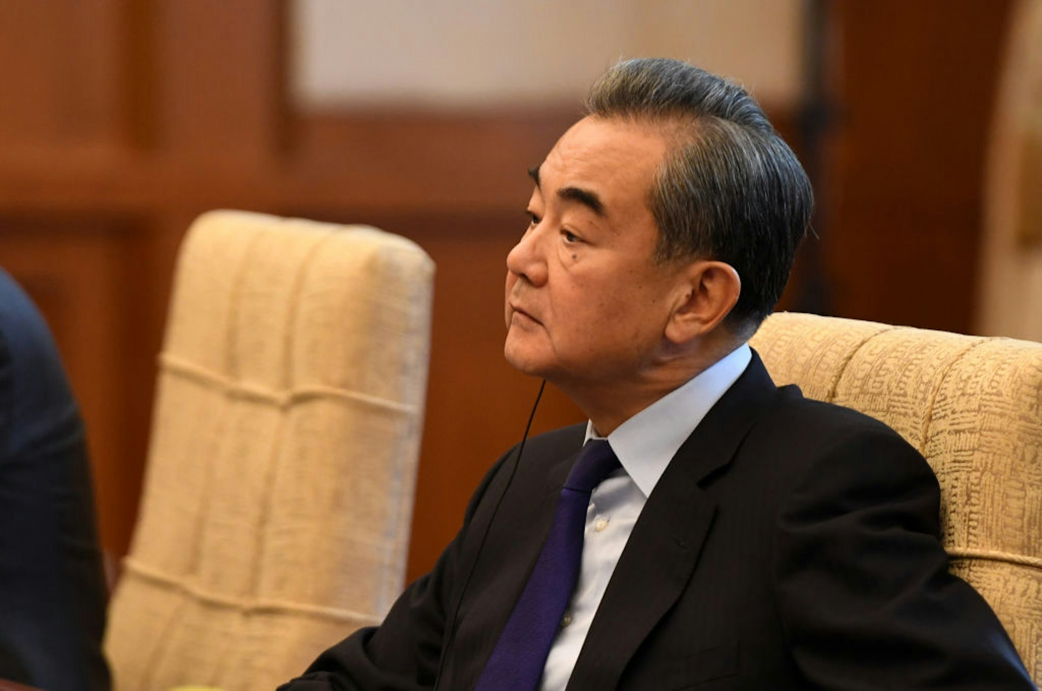 China's Foreign Minister Wang Yi listens to Iran's Foreign Minister Mohammad Javad Zarif (not pictured) during a meeting at the Diaoyutai state guest house on December 31, 2019 in Beijing, China.