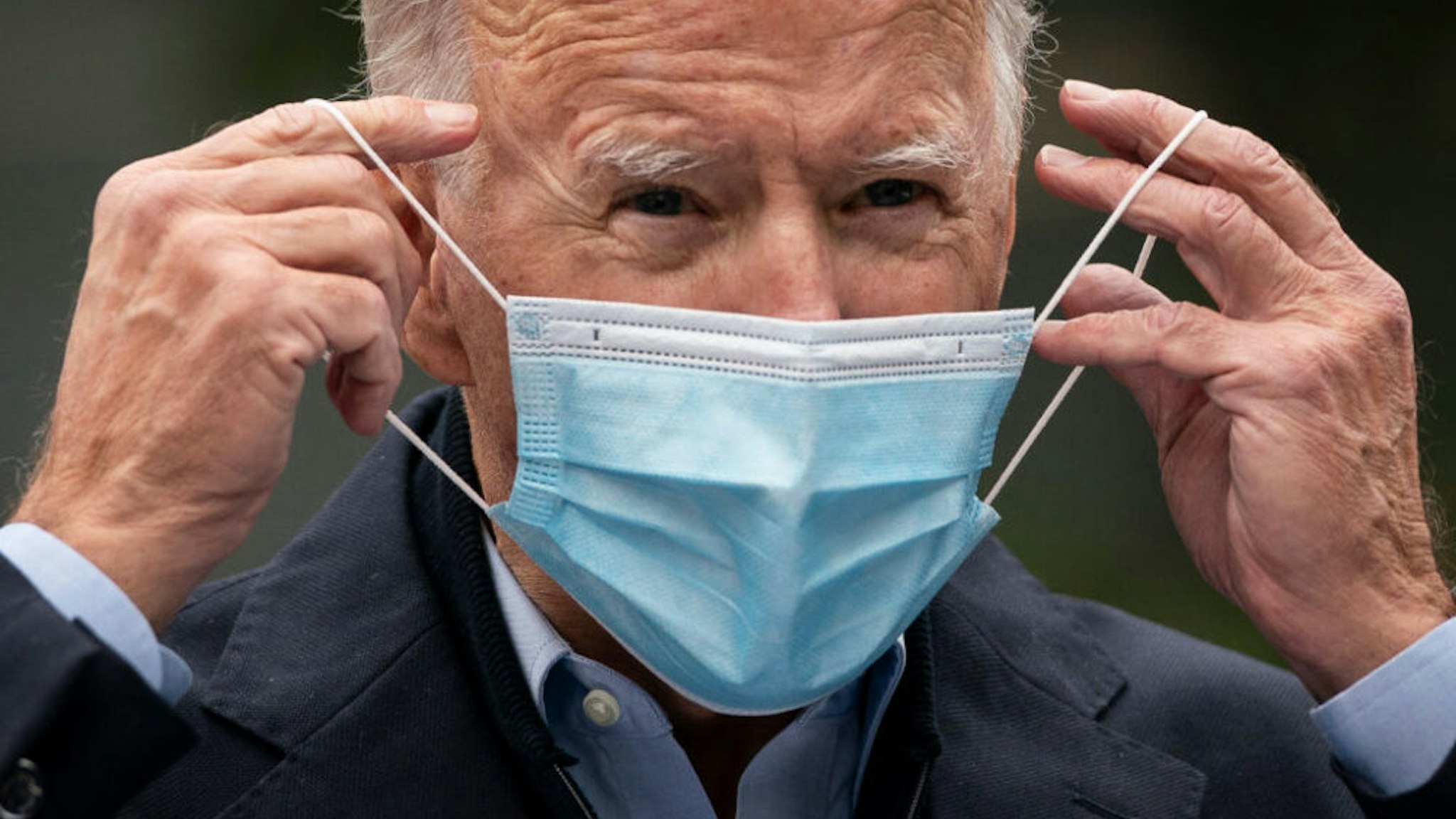 CHESTER, PA - OCTOBER 26: Democratic presidential nominee Joe Biden puts on a face mask while speaking to reporters at a voter mobilization center on October 26, 2020 in Chester, Pennsylvania. In Pennsylvania, Tuesday, October 27 is the last day to request a mail-in ballot or to vote early in person.