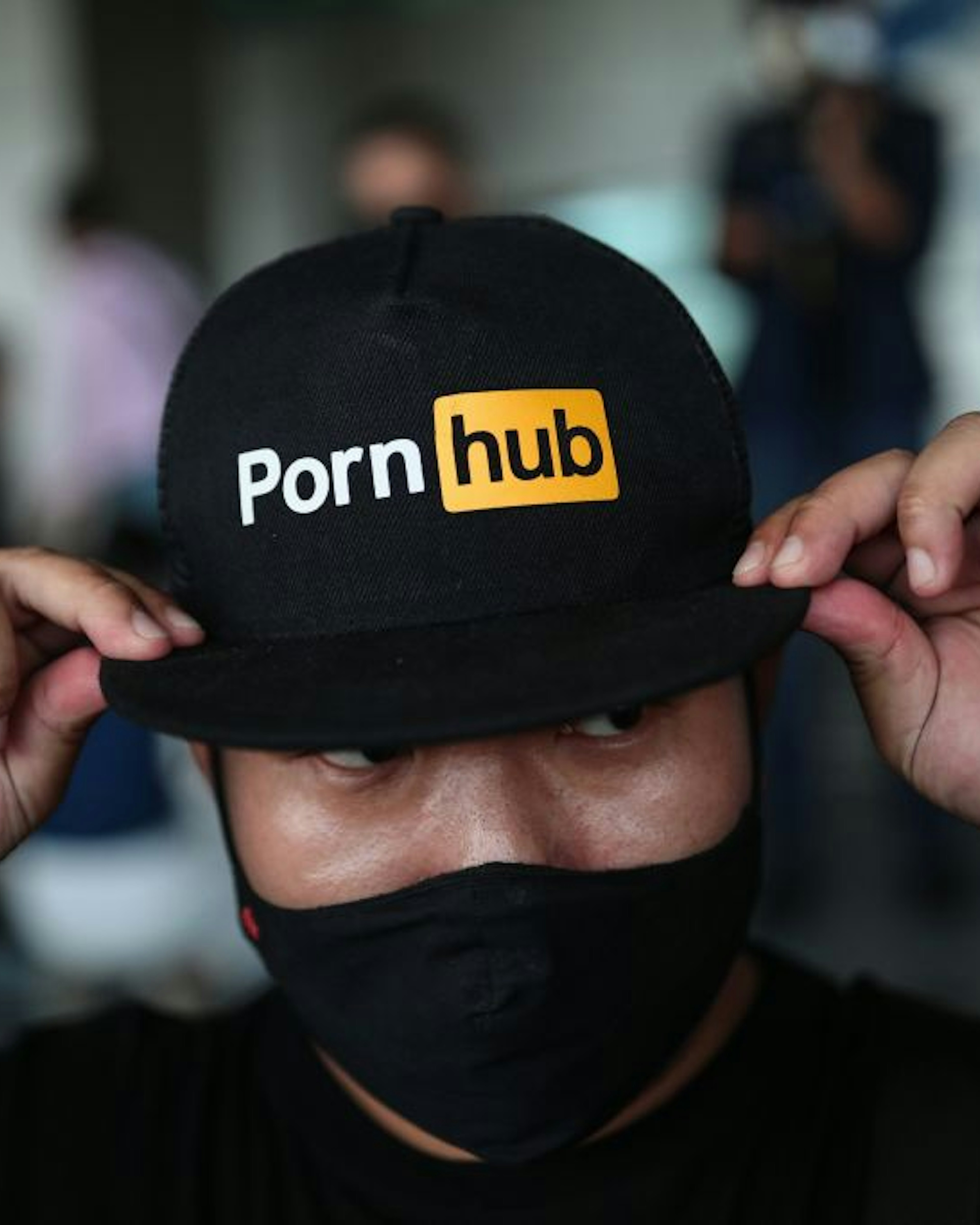 A protester wears a cap with the Pornhub logo during a demonstration at the Ministry of Digital Economy and Society in Bangkok on November 3, 2020, after the website was blocked by the ministry. (Photo by Jack TAYLOR / AFP) (Photo by JACK TAYLOR/AFP via Getty Images)