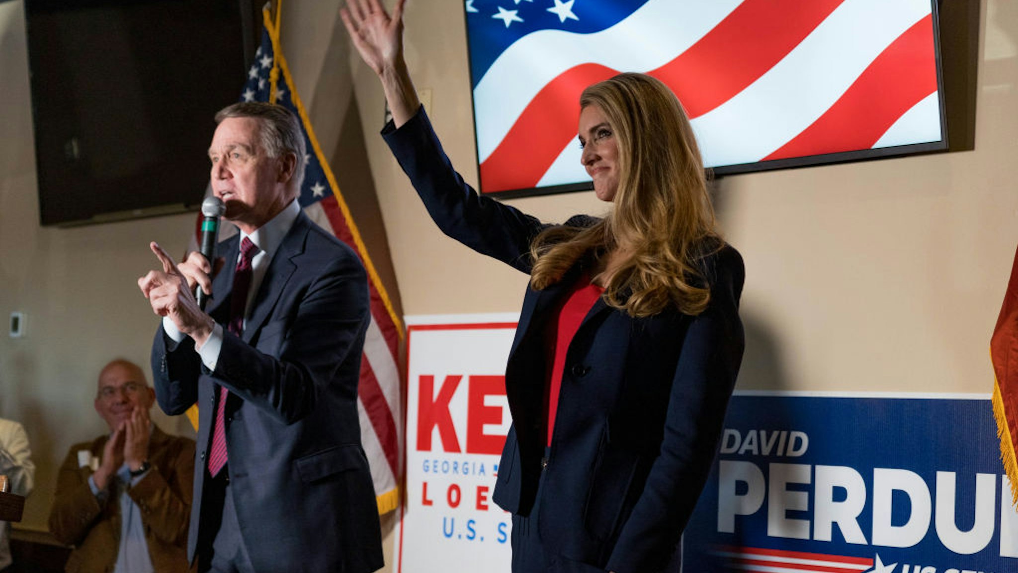 U.S. Sen David Perdue (R-GA) and Sen Kelly Loeffler (R-GA) speaks at a campaign event to supporters at a restaurant on November 13, 2020 in Cumming, Georgia.