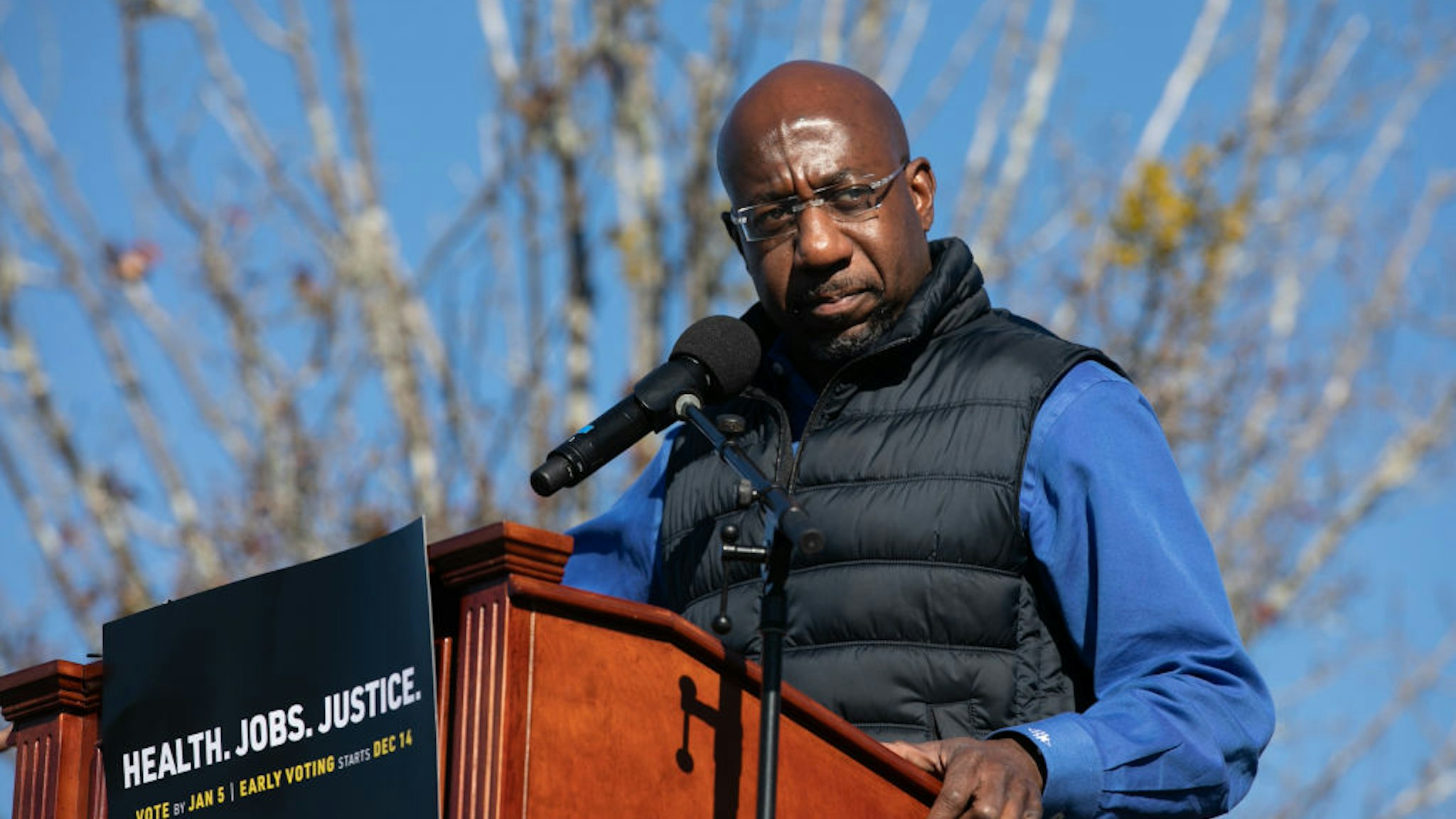 Democratic U.S. Senate candidate Raphael Warnock speaks to the crowd during an outdoor drive-in rally on December 5, 2020 in Conyers, Georgia.
