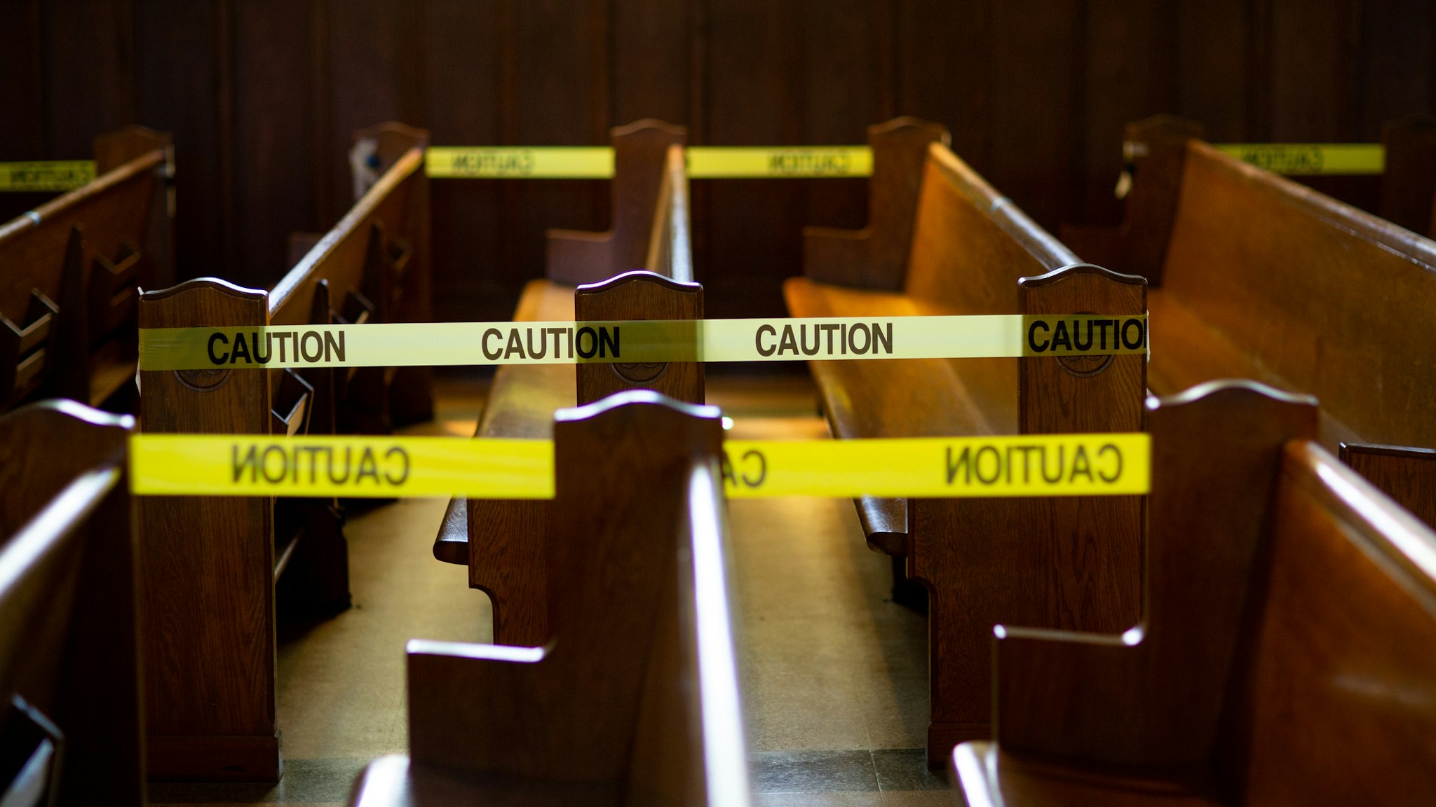 Caution tape blocks off church pews in regulation with social distancing guidelines due to Coronavirus.