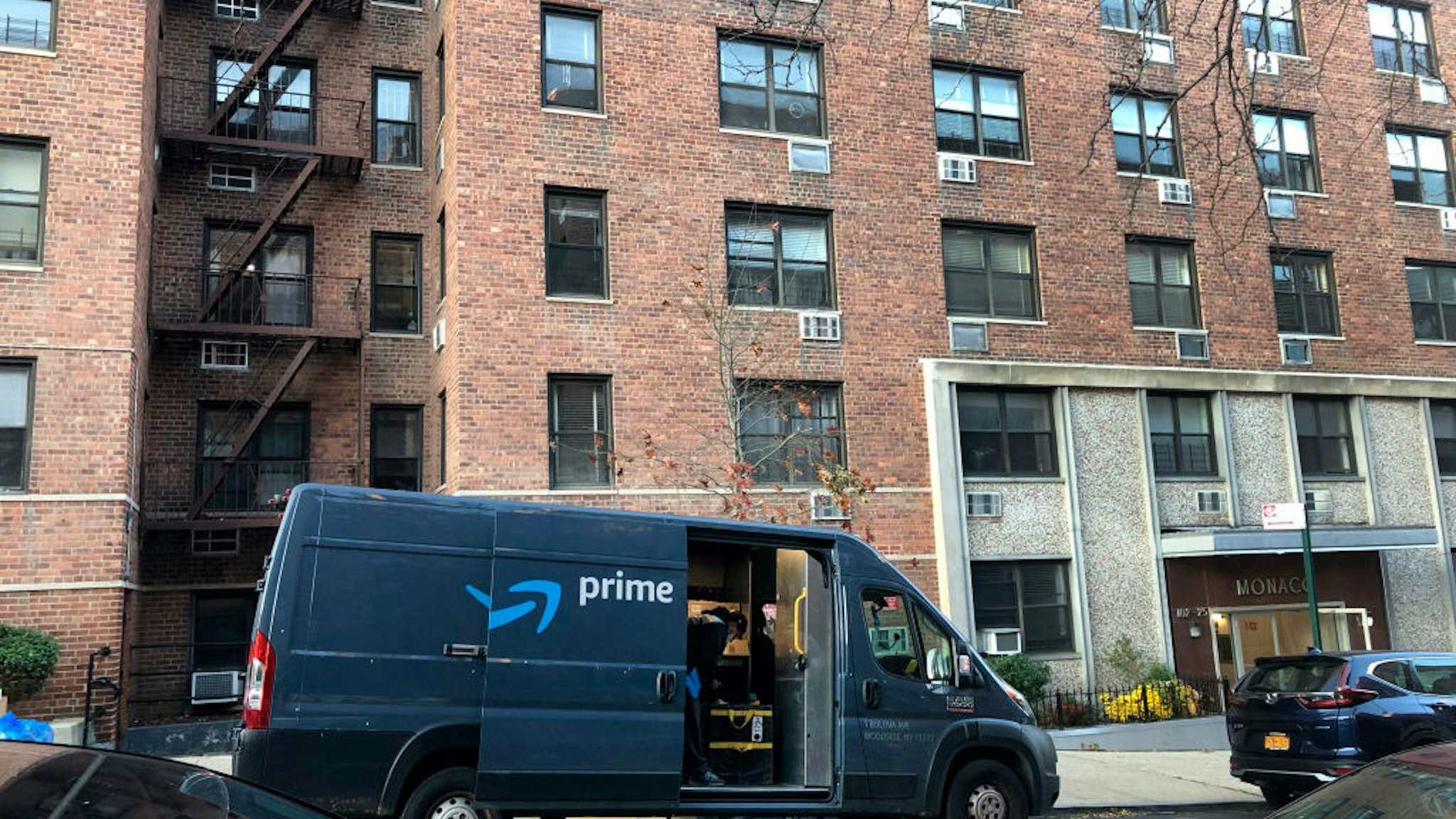 Amazon Prime delivery van parked outside apartment building, Forest Hills, Queens, NY.