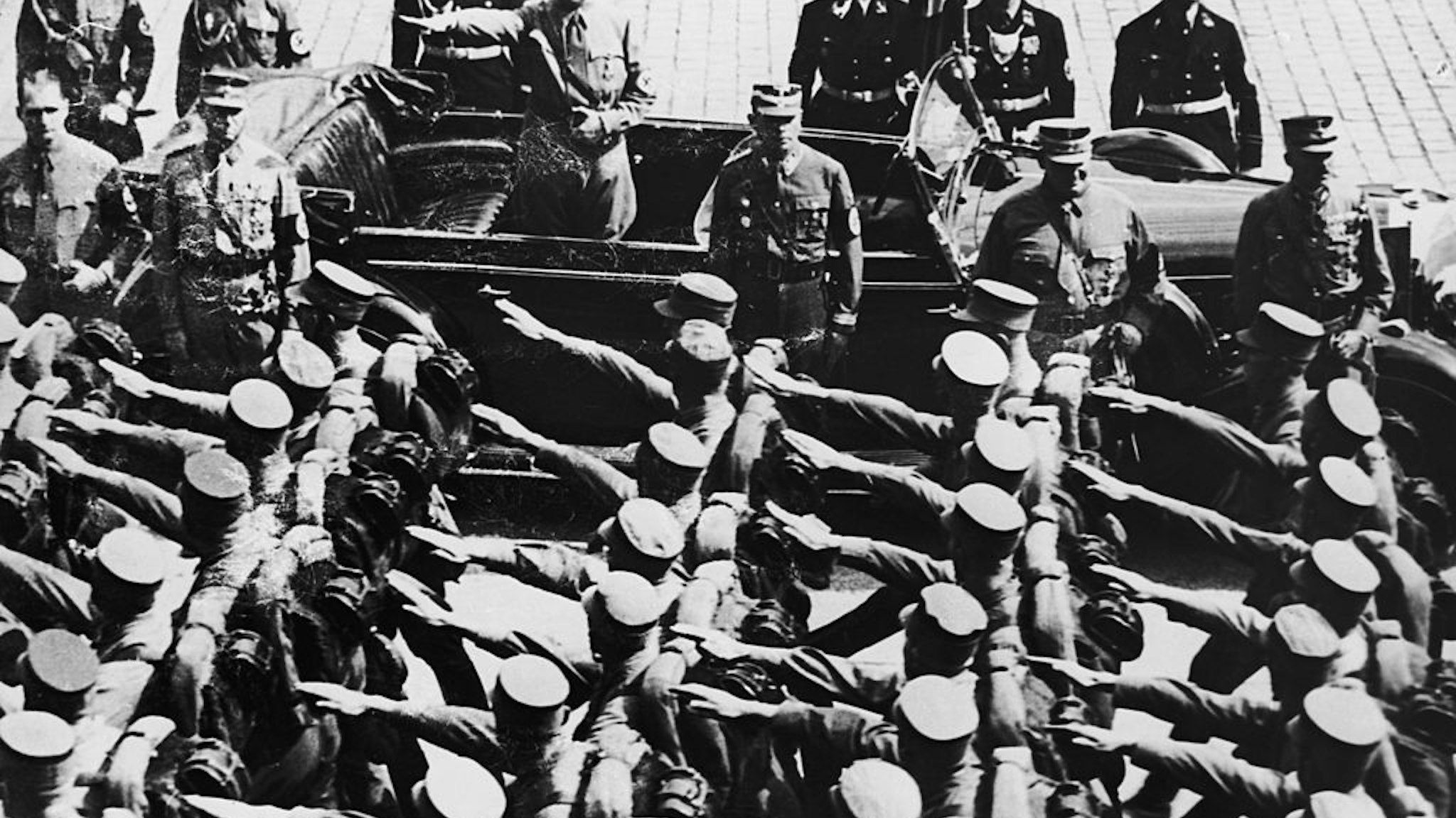 Nazi leader Adolf Hitler (1889 - 1945) takes a salute at a parade in the Adolf Hitler Platz, during the Nuremberg Congress, 12th September 1938.