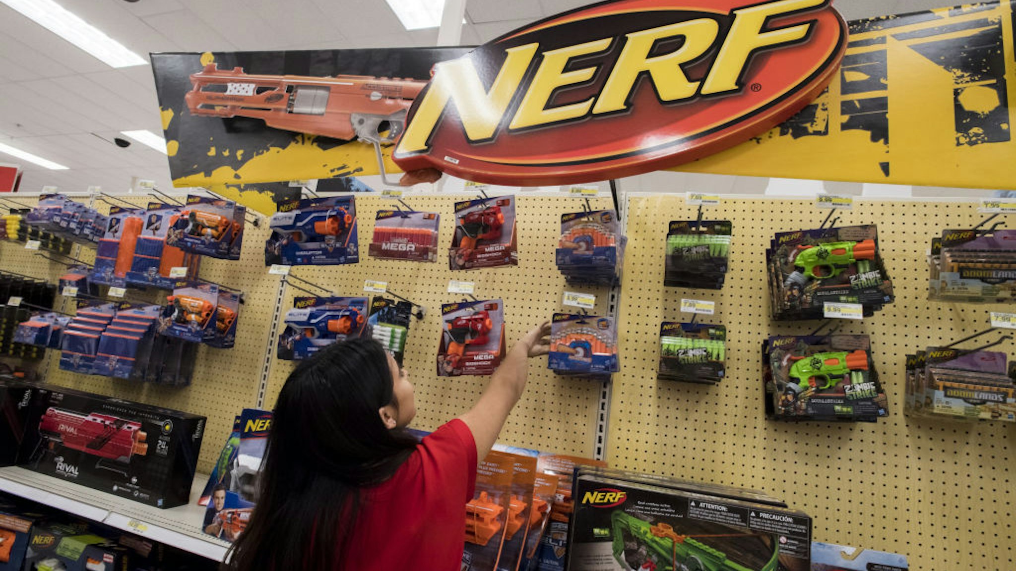 A worker arranges a shelf of Hasbro Inc. Nerf Blaster products at a Target Corp. location in Emeryville, California, U.S.
