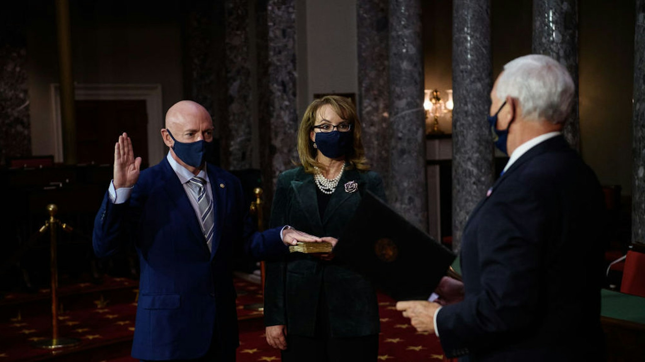Senator Mark Kelly, a Democrat from Arizona, left, is ceremoniously sworn-in by U.S. Vice President Mike Pence, right, beside his wife, former congresswoman Gabrielle Giffords, on Capitol Hill in Washington, D.C., U.S., on Wednesday, Dec. 2, 2020. Kelly, a former astronaut, defeated Senator Martha McSally in a special election last month.