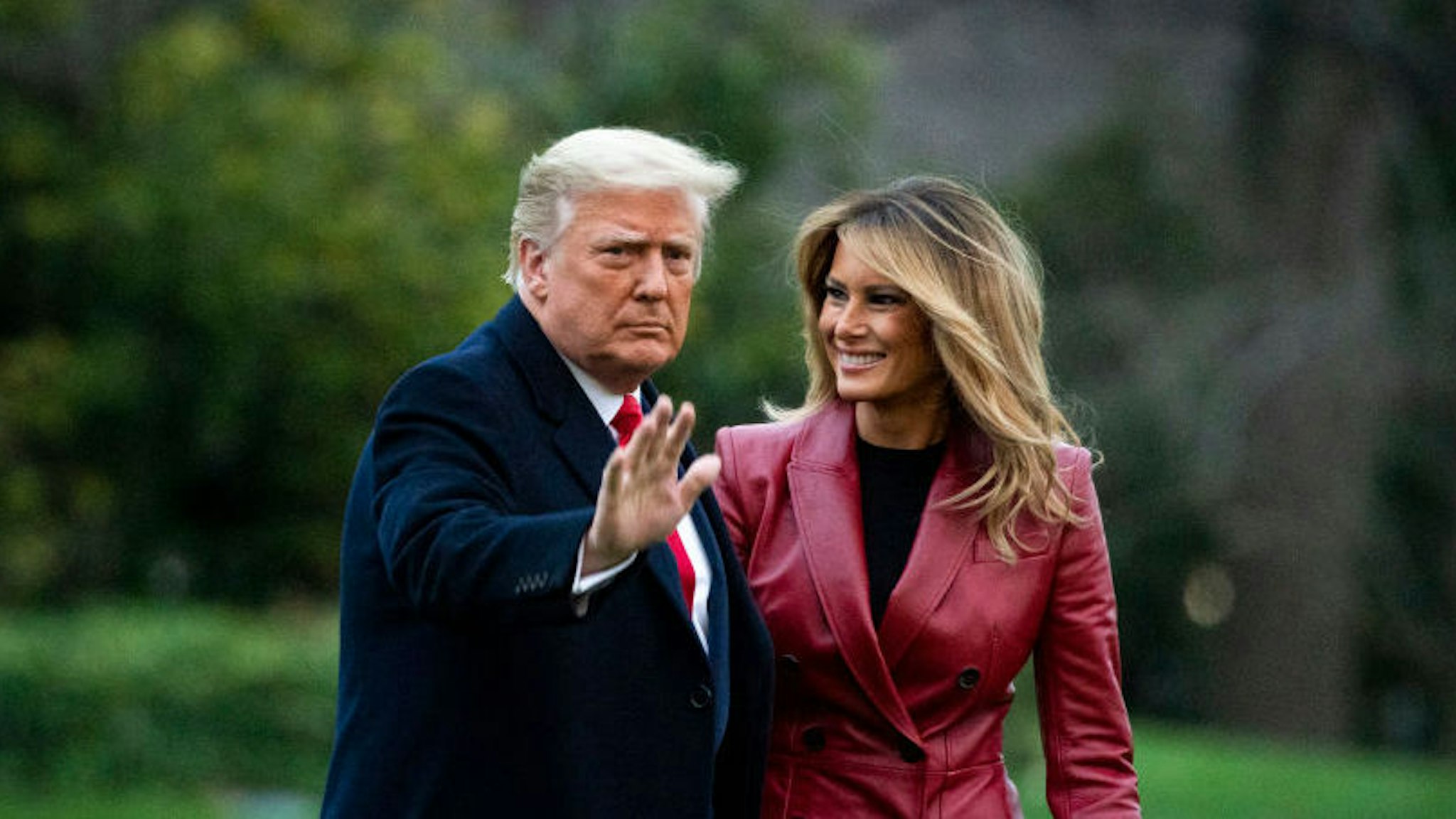 WASHINGTON, DC - DECEMBER 05: U.S. President Donald Trump waves as he walks with First lady Melania Trump as they depart on the South Lawn of the White House, on December 5, 2020 in Washington, DC. Trump is traveling to Georgia to hold a rally.