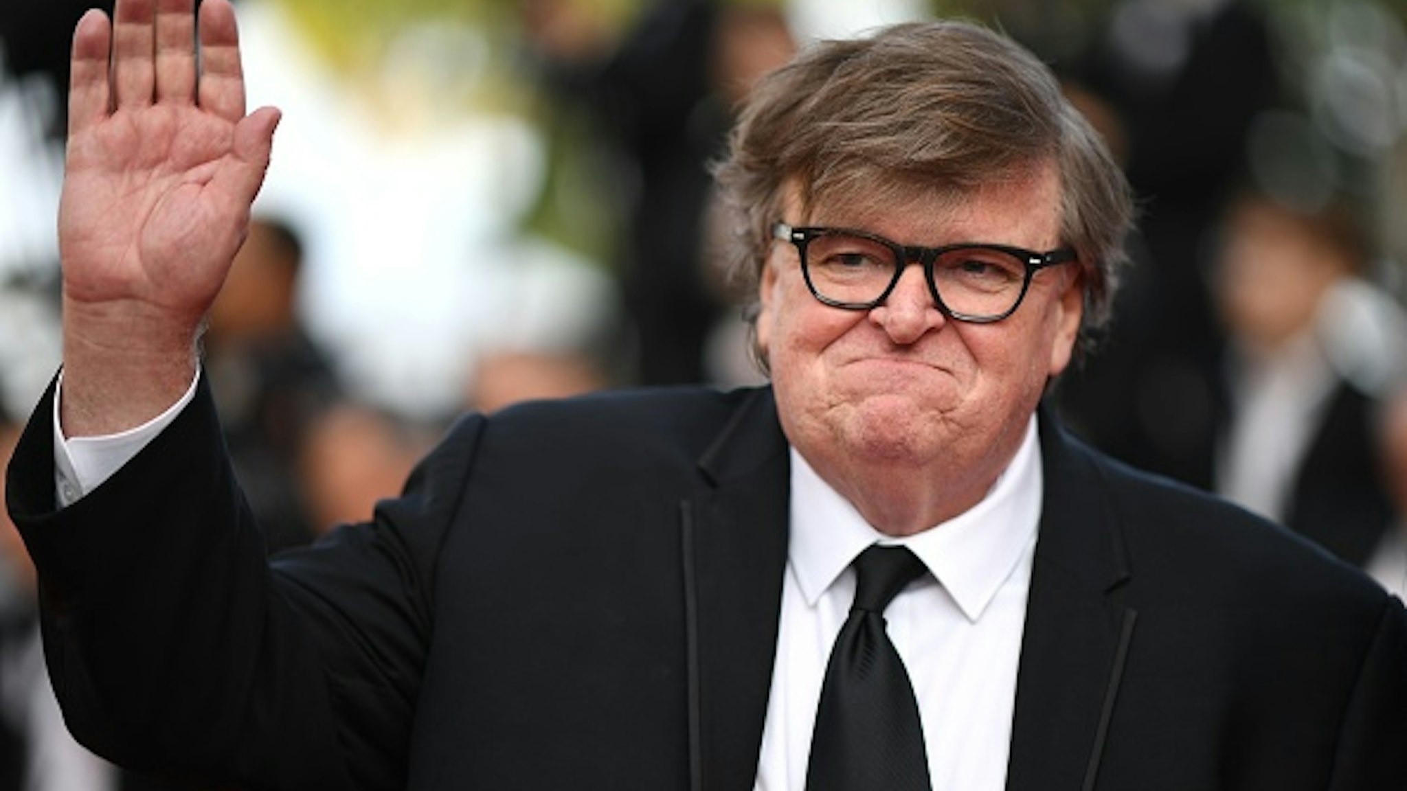 US director Michael Moore waves as he arrives for the screening of the film "The Specials (Hors Normes)" at the 72nd edition of the Cannes Film Festival in Cannes, southern France, on May 25, 2019.