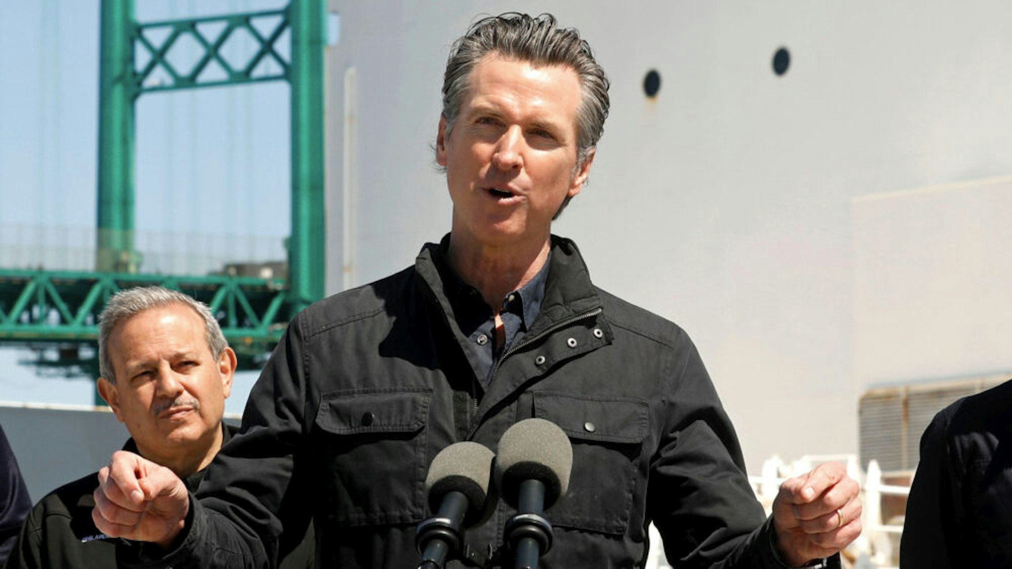 California Governor Gavin Newsom (C), flanked by (from L) Robert Fenton, FEMA Regional Administrator for Region 9, Director Mark Ghilarducci, Cal OES, and Los Angeles Mayor Eric Garcetti, speaks in front of the hospital ship USNS Mercy after it arrived into the Port of Los Angeles on March 27, 2020. - The USNS Mercy, a giant US naval hospital ship, arrived in Los Angeles on March 27, where it will be used to ease the strain on the city's coronavirus-swamped emergency rooms.