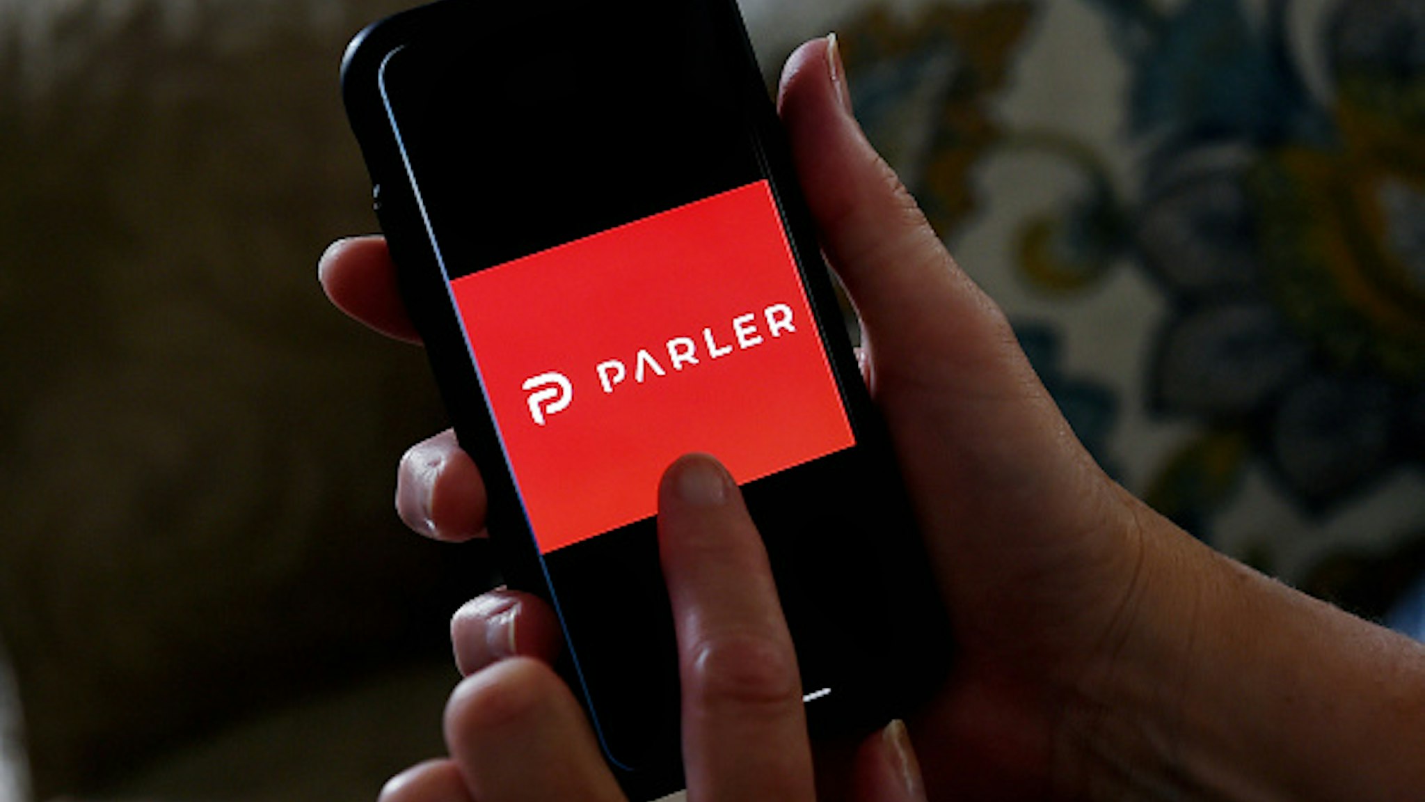 This illustration picture shows social media application logo from Parler displayed on a smartphone in Arlington, Virginia on July 2, 2020. - Amid rising turmoil in social media, recently formed social network Parler is gaining with prominent political conservatives who claim their voices are being silenced by Silicon Valley giants. Parler, founded in Nevada in 2018, bills itself as an alternative to "ideological suppression" at other social networks.