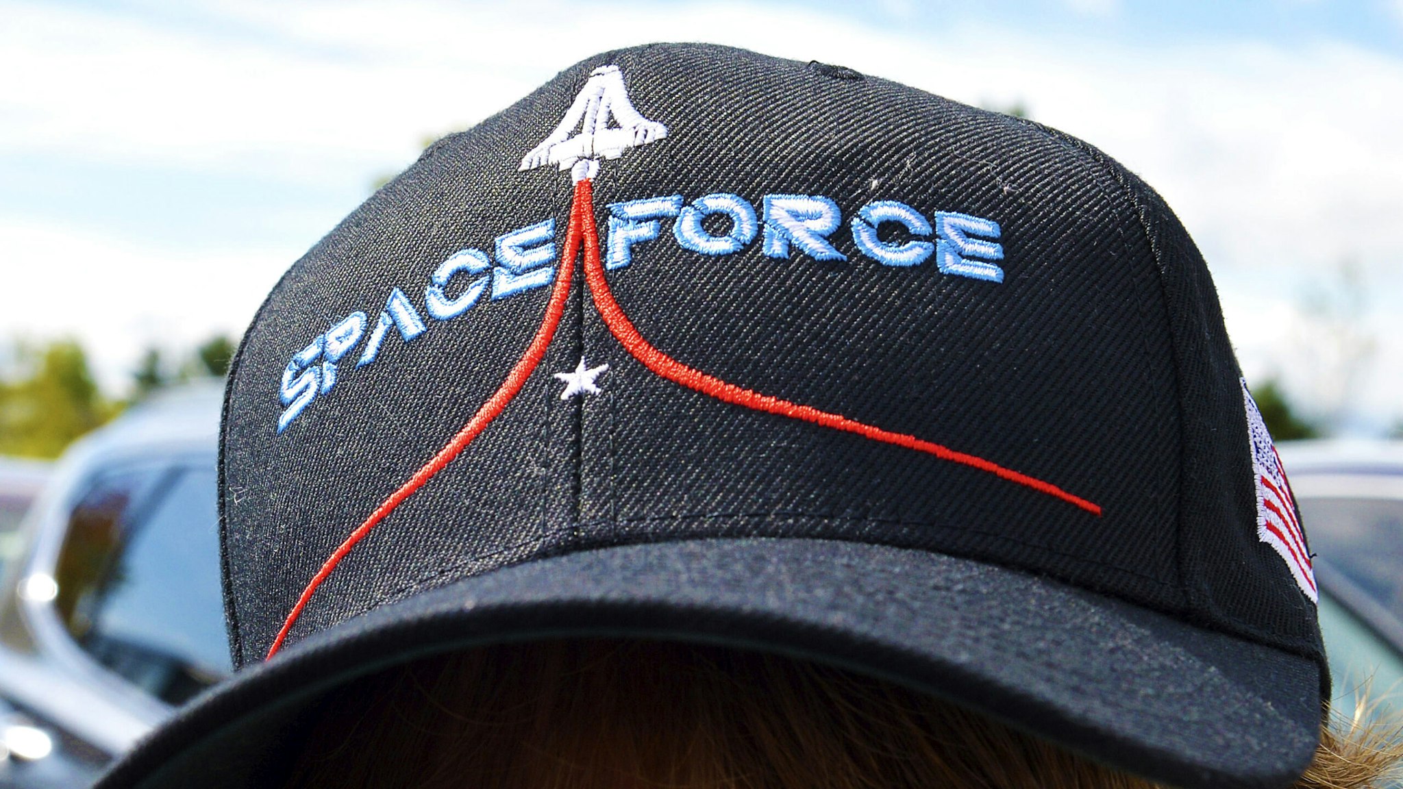 A woman wears a Space Force hat while boarding a shuttle bus at the Manchester Mall going to Manchester Airport in Londonderry, New Hampshire on August 28, 2020. - US President Donald Trump is scheduled to speak to supporters in Londonderry on August 28.