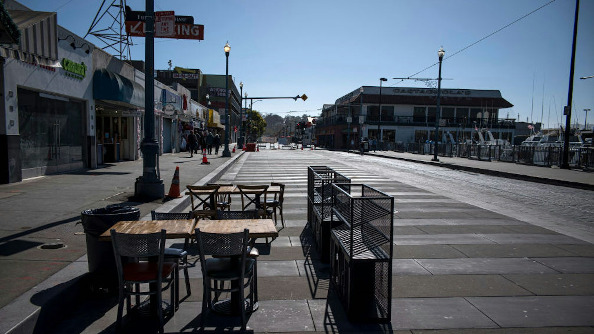 Empty tables and chairs stand outside a restaurant on Jefferson Street at Fisherman's Wharf in San Francisco, California, U.S., on Wednesday, July 8, 2020. Built from the rubble of the 1906 earthquake and fire, the Wharf is now facing a different sort of rebuild after Covid-19 economically flattened it.