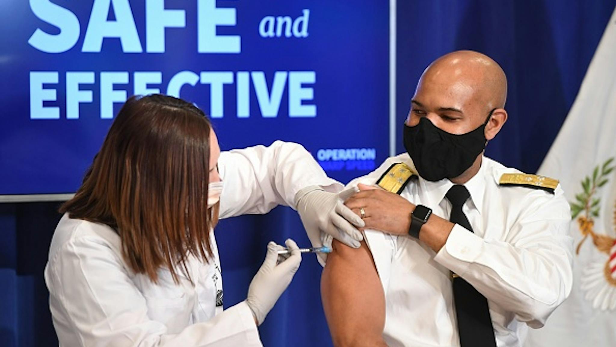 US-HEALTH-VIRUS-POLITICS-PENCE-VACCINE US Surgeon General Jerome Adams receives the COVID-19 vaccine in the Eisenhower Executive Office Building in Washington, DC, December 18, 2020.