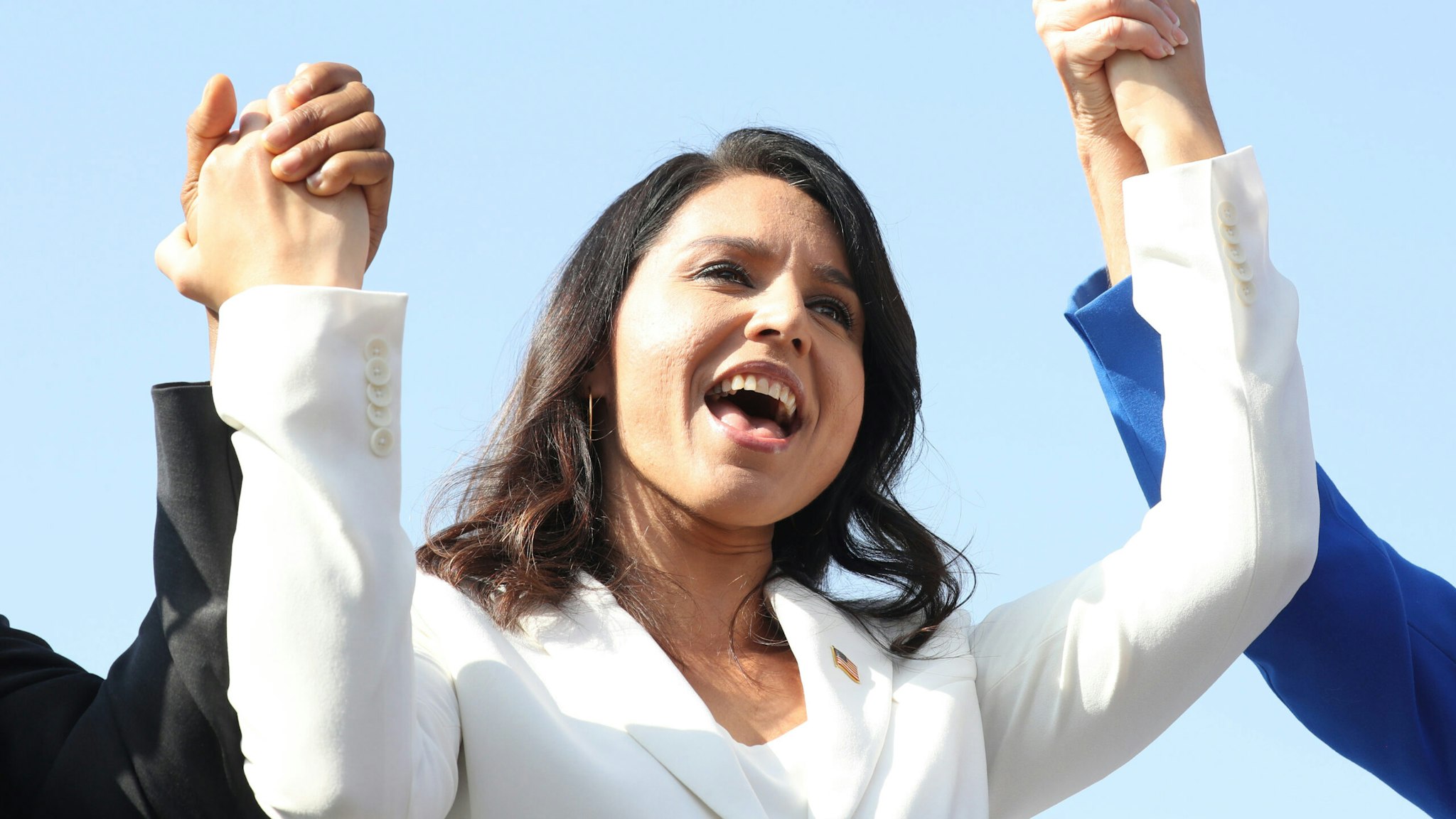 LOS ANGELES, CALIFORNIA - NOVEMBER 11: Democratic presidential candidate U.S. Rep. Tulsi Gabbard (D-HI) sings during the inaugural Veterans Day L.A. event held outside of the Los Angeles Memorial Coliseum on November 11, 2019 in Los Angeles, California. The stadium's historic torch was lit at the ceremony to mark the anniversary of the armistice which ended World War I in 1918. Gabbard is the first female combat veteran to run for the U.S. presidency.