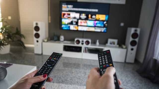 Man and woman with television remote control