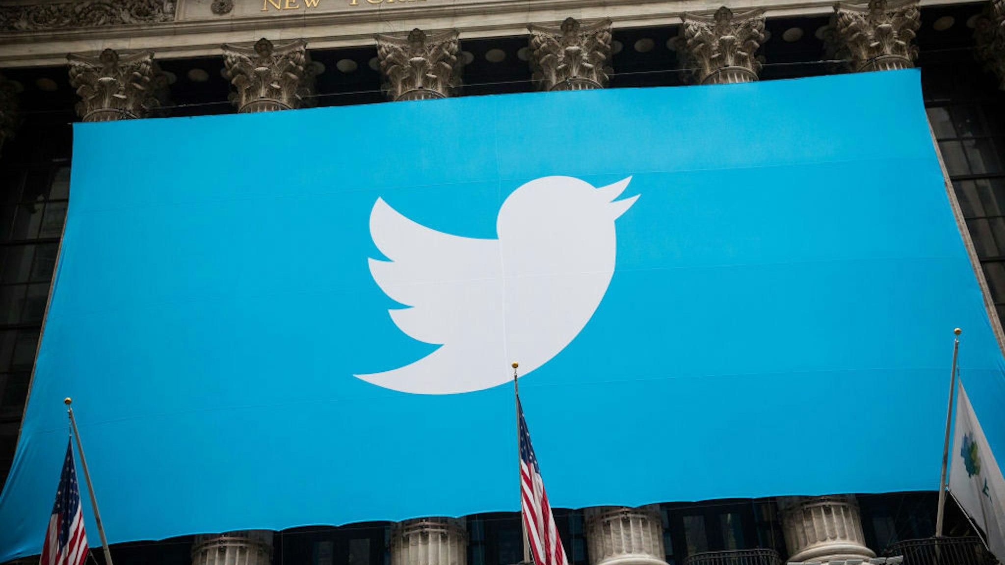 NEW YORK, NY - NOVEMBER 07: The Twitter logo is displayed on a banner outside the New York Stock Exchange (NYSE) on November 7, 2013 in New York City. Twitter goes public on the NYSE today and is expected to open at USD 26 per share, making the company worth an estimated USD 18 billion. (Photo by Andrew Burton/Getty Images)