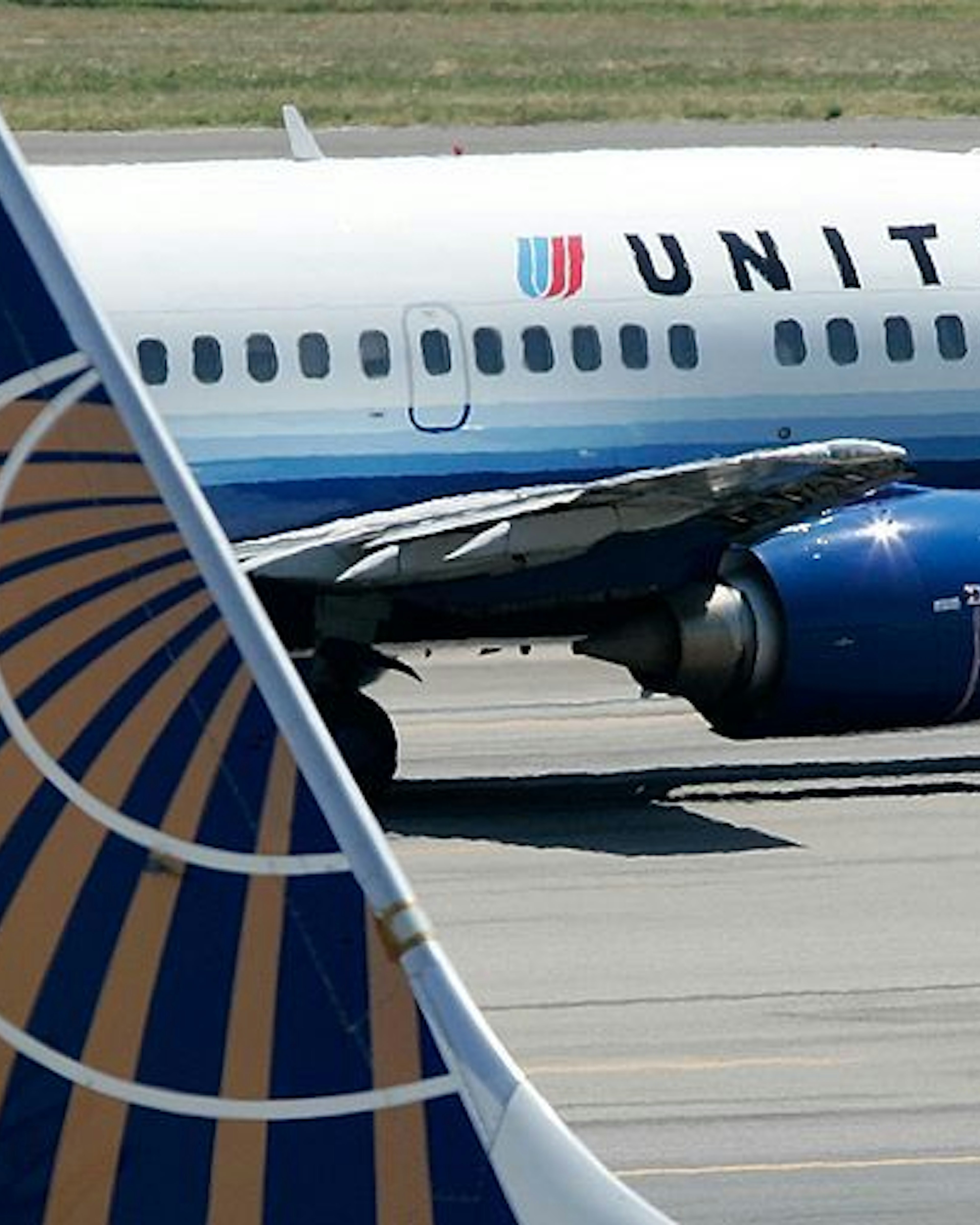 A United Airlines aircraft passes by a Continental Airlines aircraft as it taxis to takeoff from the runway of Ronald Reagan National Airport August 16, 2006 in Washington, DC. (Photo by Alex Wong/Getty Images)