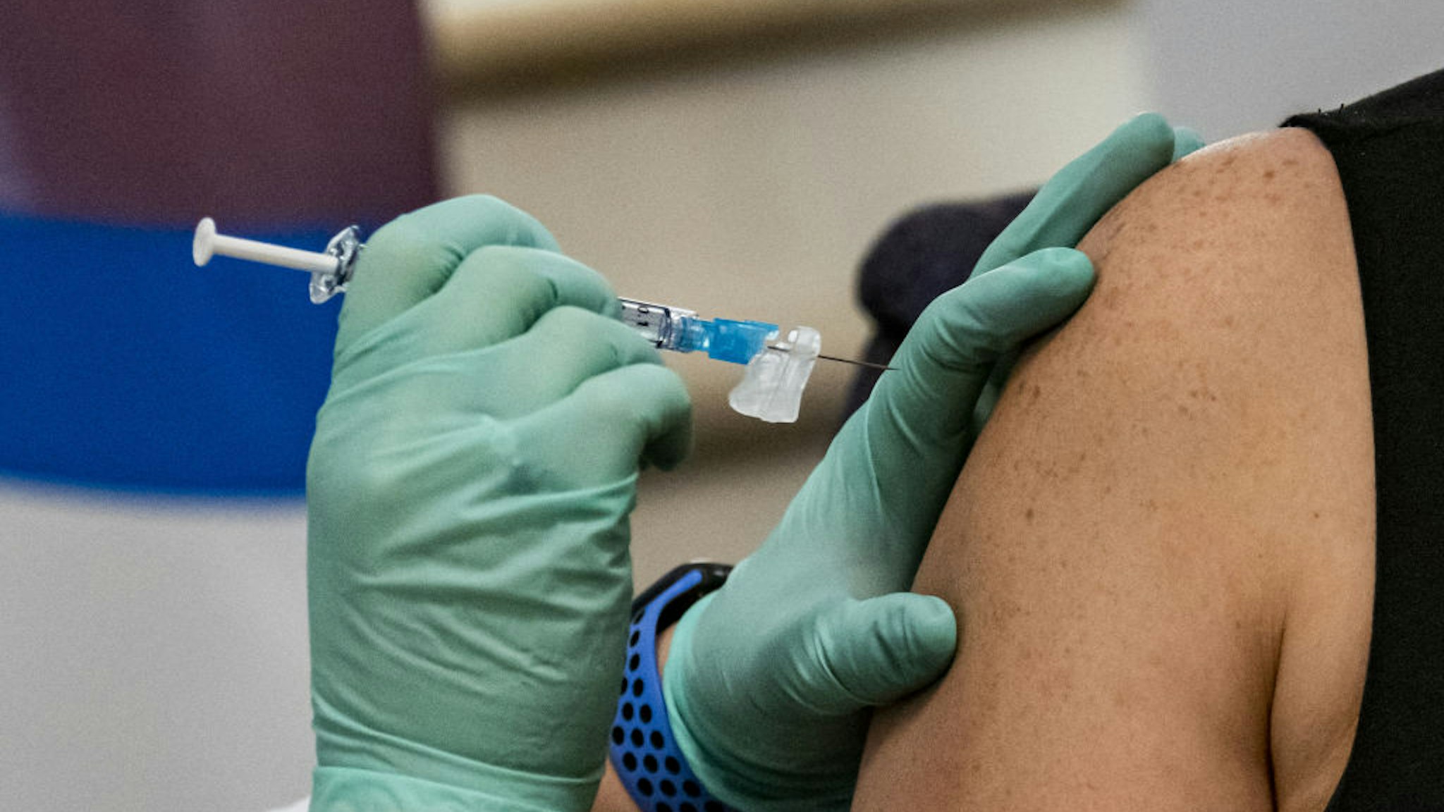 A healthcare worker receives the Pfizer-BioNTech Covid-19 vaccine at Regional Medical Center in San Jose, California, U.S., on Friday, Dec. 18, 2020. Vaccinations in the U.S. began this week with health-care workers, and 24 states reported the first 49,567 doses administered.
