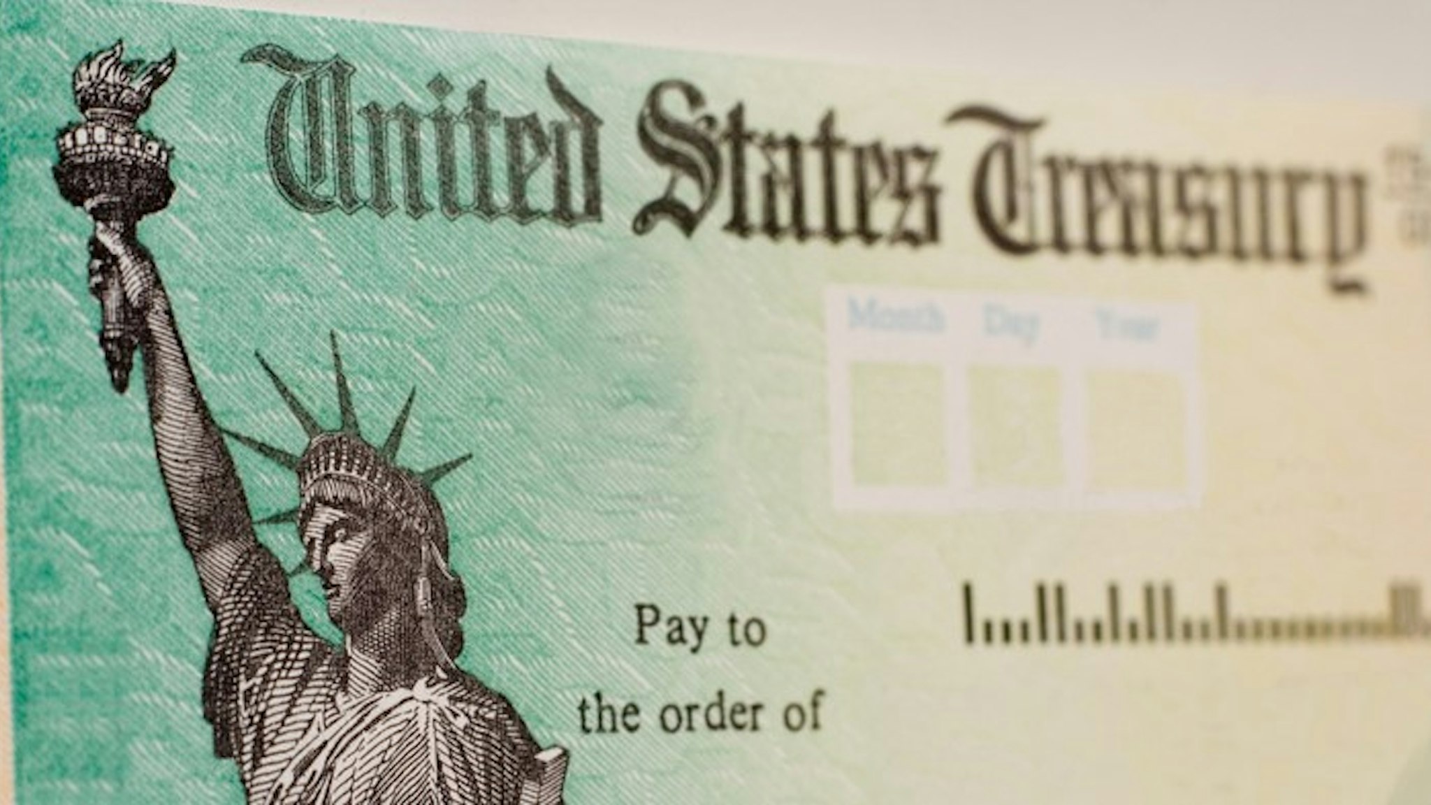 A blank US government check with selective focus on the statue of liberty