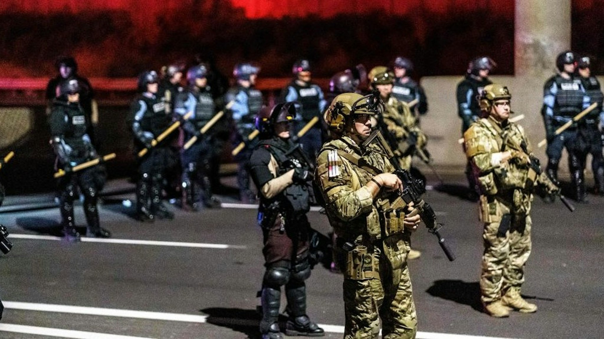 Minneapolis Police Department officers form a line to control demonstrators after declaring an unlawful assembly in Minneapolis, Minnesota on November 4, 2020. - Protestors and journalists were released later in the night. Democrats and Republicans girded November 4 for a legal showdown to decide the winner of the tight presidential race between Republican Donald Trump and Democrat Joe Biden. (Photo by Kerem Yucel / AFP) (Photo by