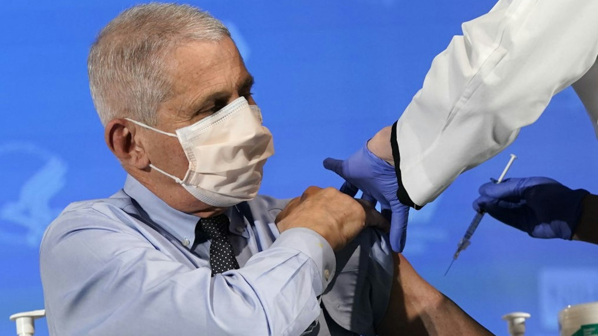 Anthony Fauci, director of the National Institute of Allergy and Infectious Diseases, receives the Moderna Inc. Covid-19 vaccine during an event at the NIH Clinical Center Masur Auditorium in Bethesda, Maryland, U.S., on Tuesday, Dec, 22, 2020. The National Institutes of Health is holding a livestreamed vaccination event to kick-off the organization's efforts for its employees on the front line of the pandemic. Photographer: