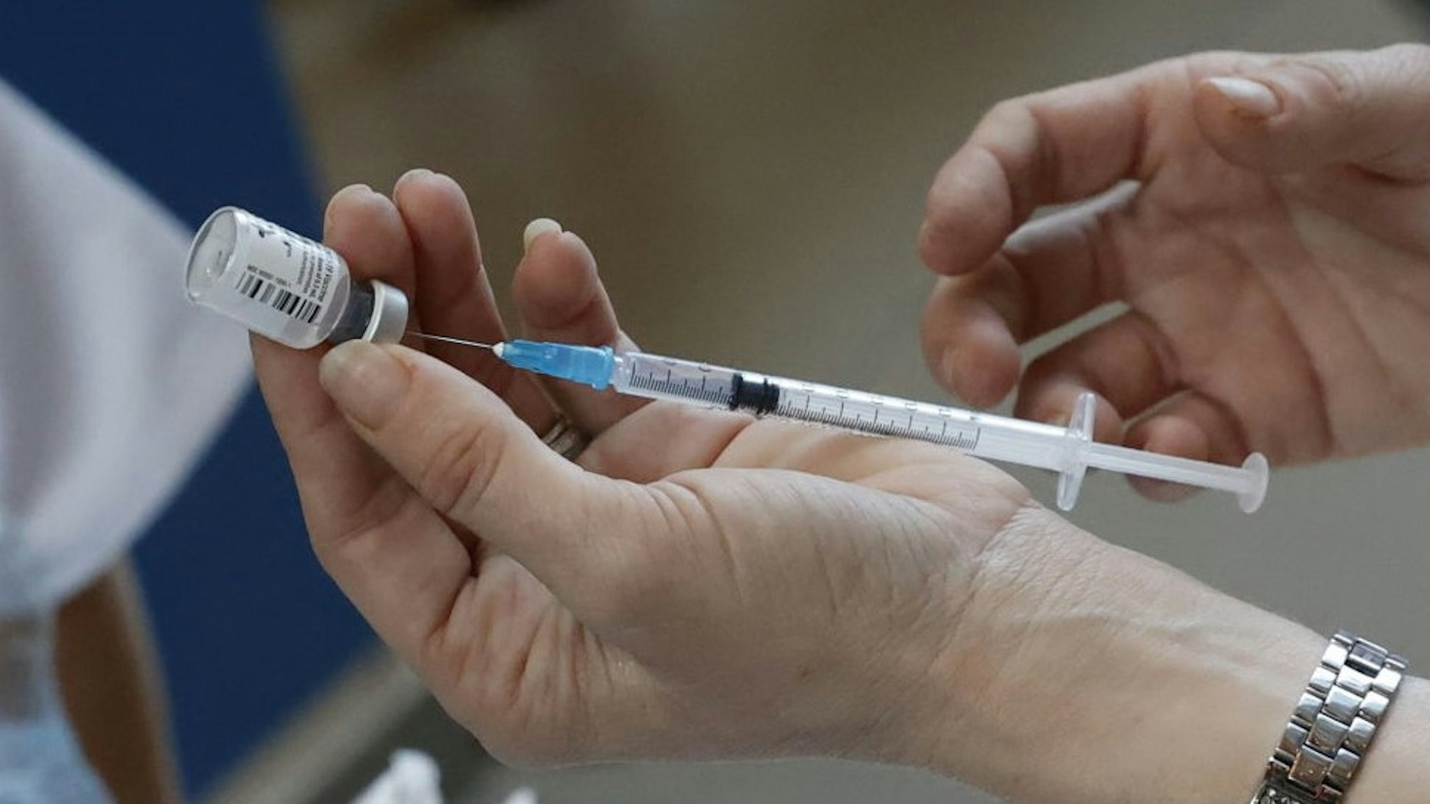 A medical worker prepares a dose of COVID-19 vaccine at Sourasky Medical Center (Ichilov) in the Israeli coastal city of Tel Aviv, on December 20, 2020. - Israel has ordered 14 million doses of the vaccine -- covering seven million people, as two doses are required per person for optimal protection -- from Pfizer as well as US biotech firm Moderna. The vaccine will be rolled out at 10 hospitals and vaccination centres around Israel for healthcare workers from Sunday, according to the health ministry. (Photo by JACK GUEZ / AFP) (Photo by