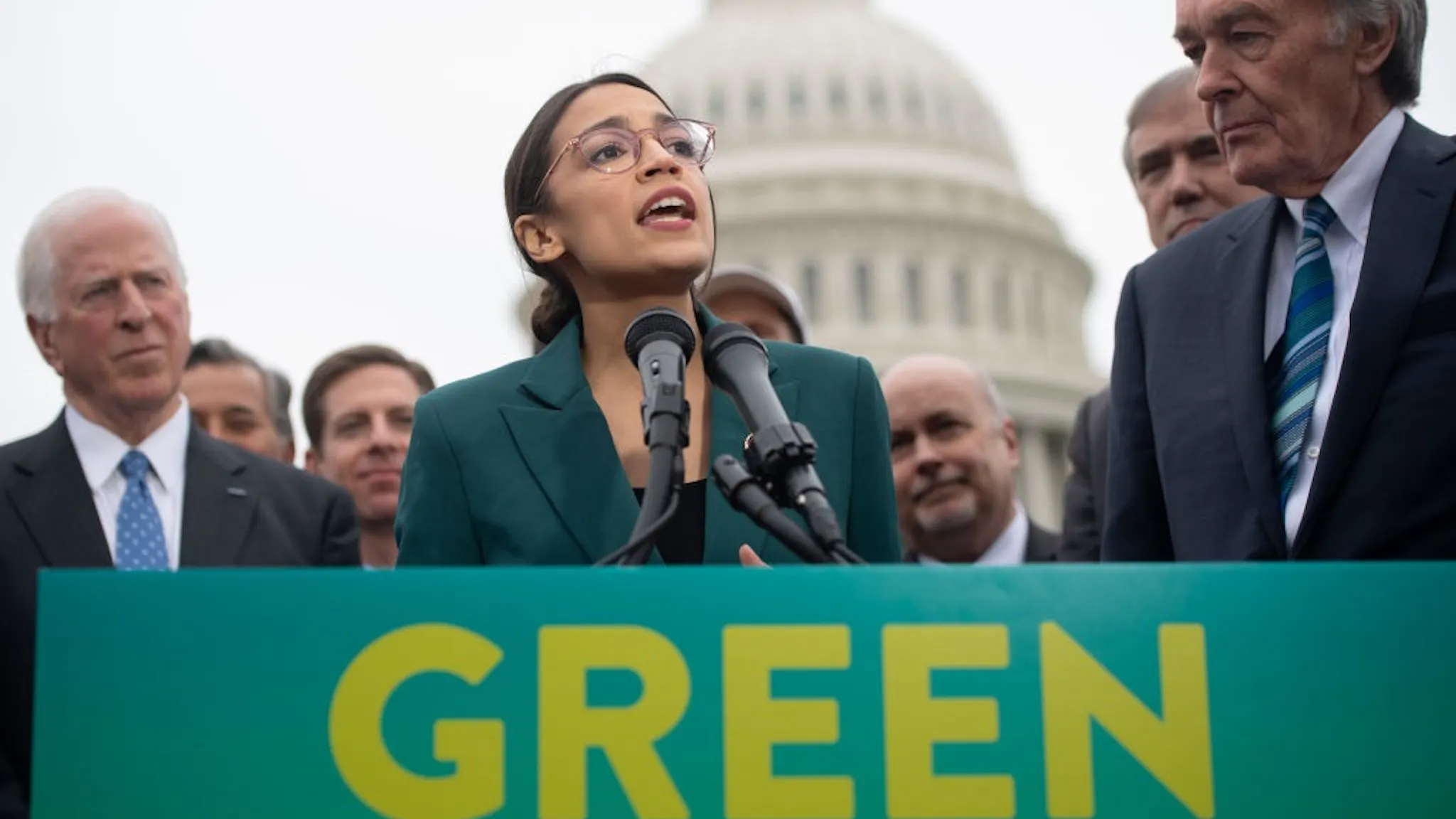AOC Green New Deal US Representative Alexandria Ocasio-Cortez, Democrat of New York, and US Senator Ed Markey (R), Democrat of Massachusetts, speak during a press conference to announce Green New Deal legislation to promote clean energy programs outside the US Capitol in Washington, DC, February 7, 2019.