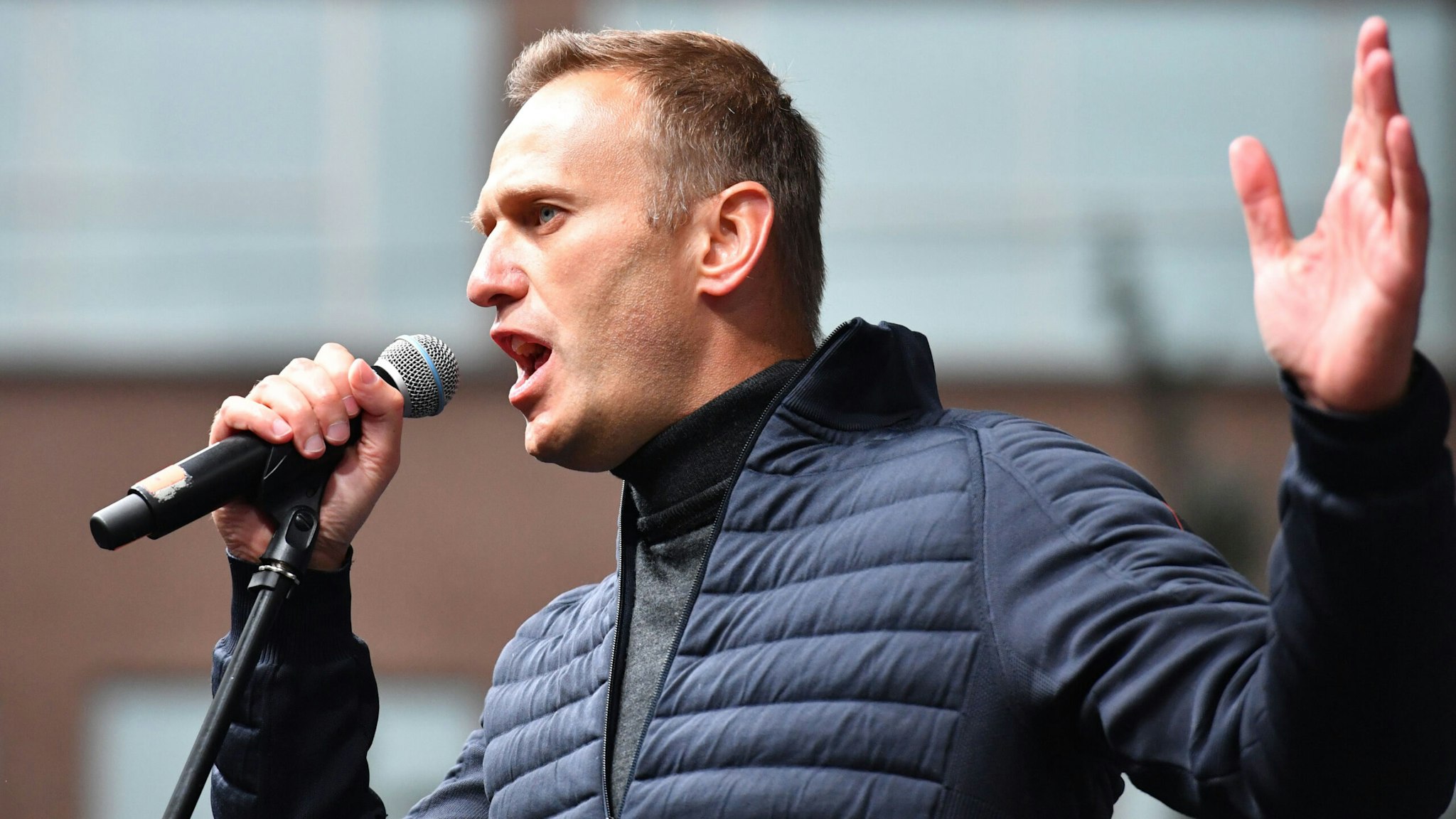 Russian opposition leader Alexei Navalny gestures as he delivers a speech during a demonstration in Moscow on September 29, 2019. - Thousands gathered in Moscow for a demonstration demanding the release of the opposition protesters prosecuted in recent months. Police estimated a turnout of 20,000 people at the Sakharov Avenue in central Moscow about half an hour after the start of the protest, which was authorised. The demonstrators chanted "let them go" and brandished placards demanding a halt to "repressions" of opposition protesters.