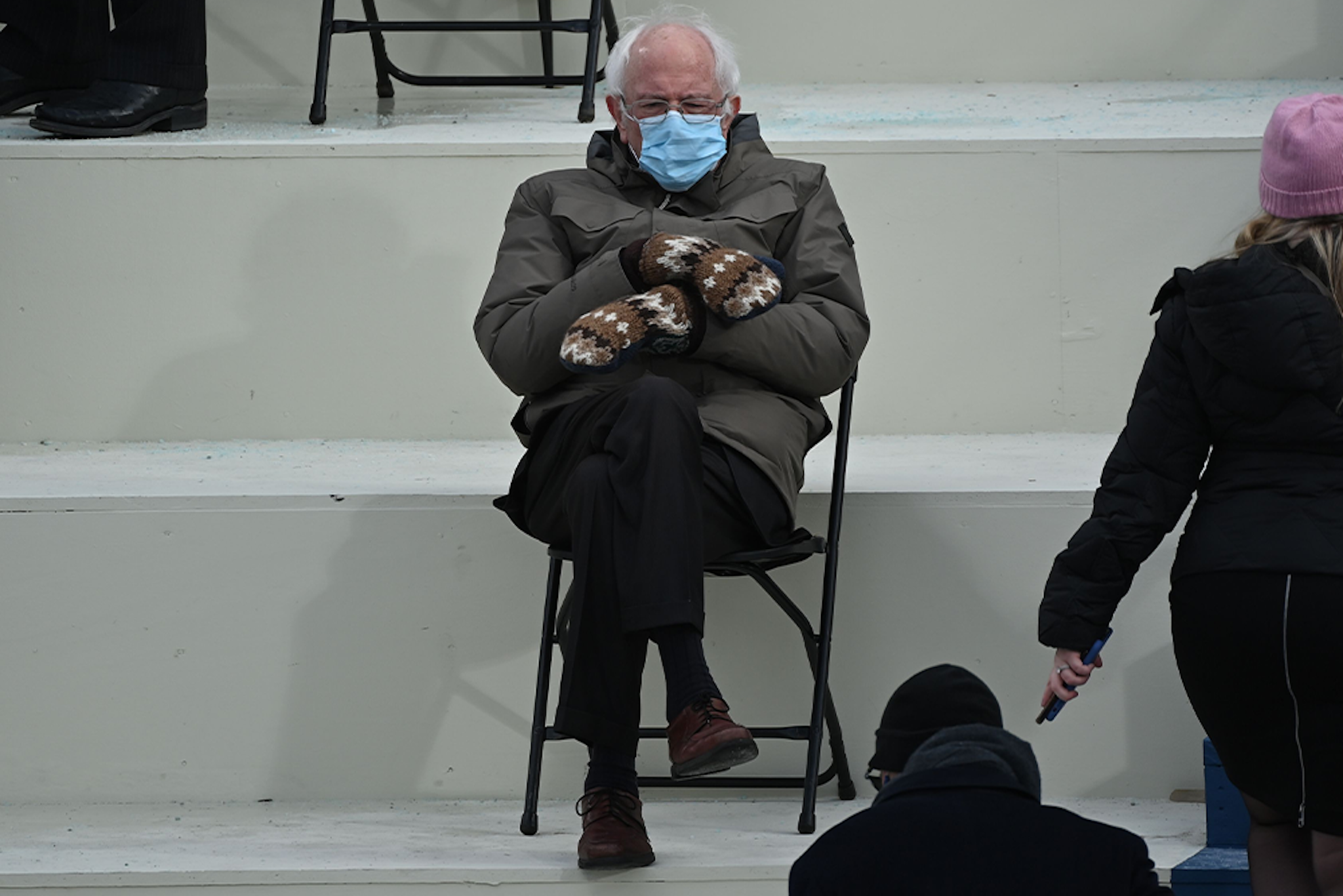 TOPSHOT - Former presidential candidate, Senator Bernie Sanders (D-Vermont) sits in the bleachers on Capitol Hill before Joe Biden is sworn in as the 46th US President on January 20, 2021, at the US Capitol in Washington, DC.