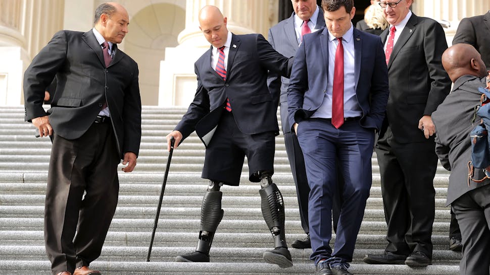 Incoming House Lawmakers Pose For Class Photo WASHINGTON, DC - NOVEMBER 15: Incoming Republican and Democratic members of Congress, including former U.S. Army Special Operations soldier and Representative-elect Brian Mast (R-FL) (2nd L), walk down the steps of the House of Representatives before posing for a group photograph November 15, 2016 in Washington, DC. There are 50 members of the freshmen class that will join the 115th Congress when it begins in January 2017.